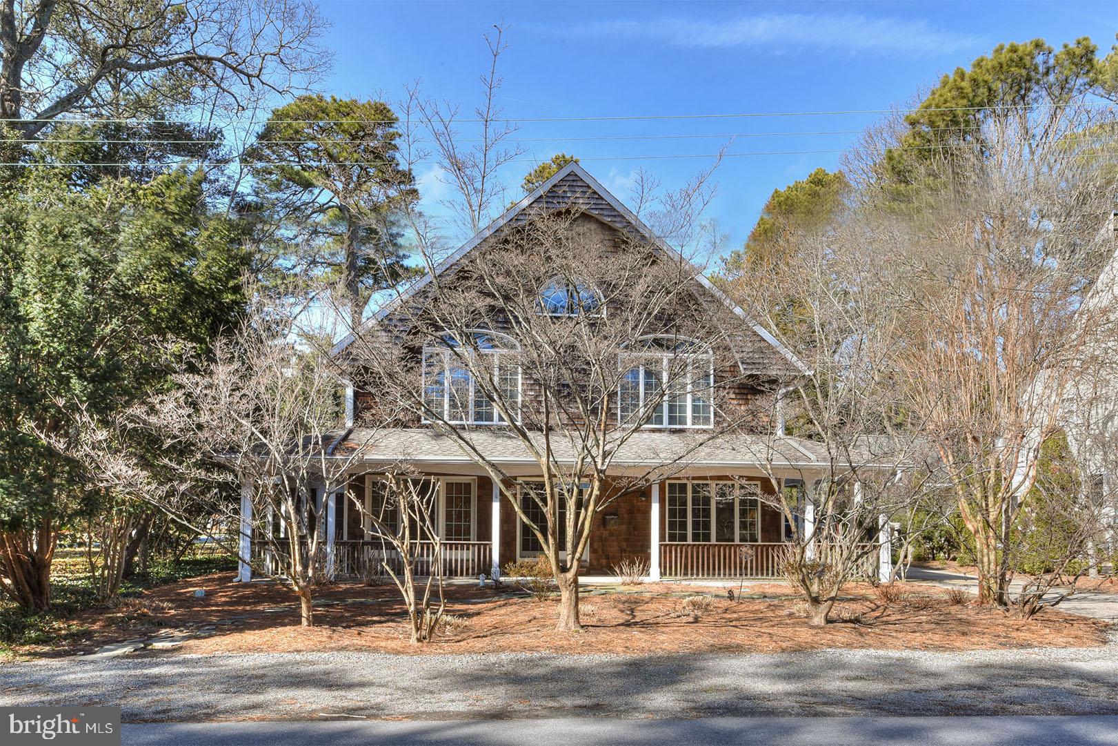 Welcome to 55 Henlopen Avenue, a classic shingle-style Rehoboth Beach home that exudes charm. Situated on an oversized 75’ x 93’ lot, this home is just steps from beautiful beaches, boardwalk, public tennis courts, and all of downtown’s finest establishments. Adjacent common area of Henlopen  Acres creates a private and beautiful wooded setting. This home features 7 generously sized bedrooms, 5 full baths, 1 half bath and over 4200 SF of heated living space. The excellent floor plan offers a space for everyone complete with a large great room, separate den, home office (and/or fitness room, sitting room), and formal dining area. The great room features built-ins and a gas fireplace, which opens to a chef’s kitchen complete with prep island, breakfast bar, beverage area with ice maker, extra fridge and plenty of cabinetry. This open space is ideal for entertaining. The two first floor suites offer en-suite baths and private entrances. Dual staircases lead you to the 2nd level that hosts 5 additional bedrooms, including the expansive primary suite, and 3 full baths. The exterior of the home is adorned with wrap around covered porches, including a screened porch, an outside shower, fenced area, and ample parking. Being sold furnished, 55 Henlopen Avenue offers the perfect setting for family and friends to gather and make endless memories on the Delaware Coast. Move in ready for the summer of 2022!