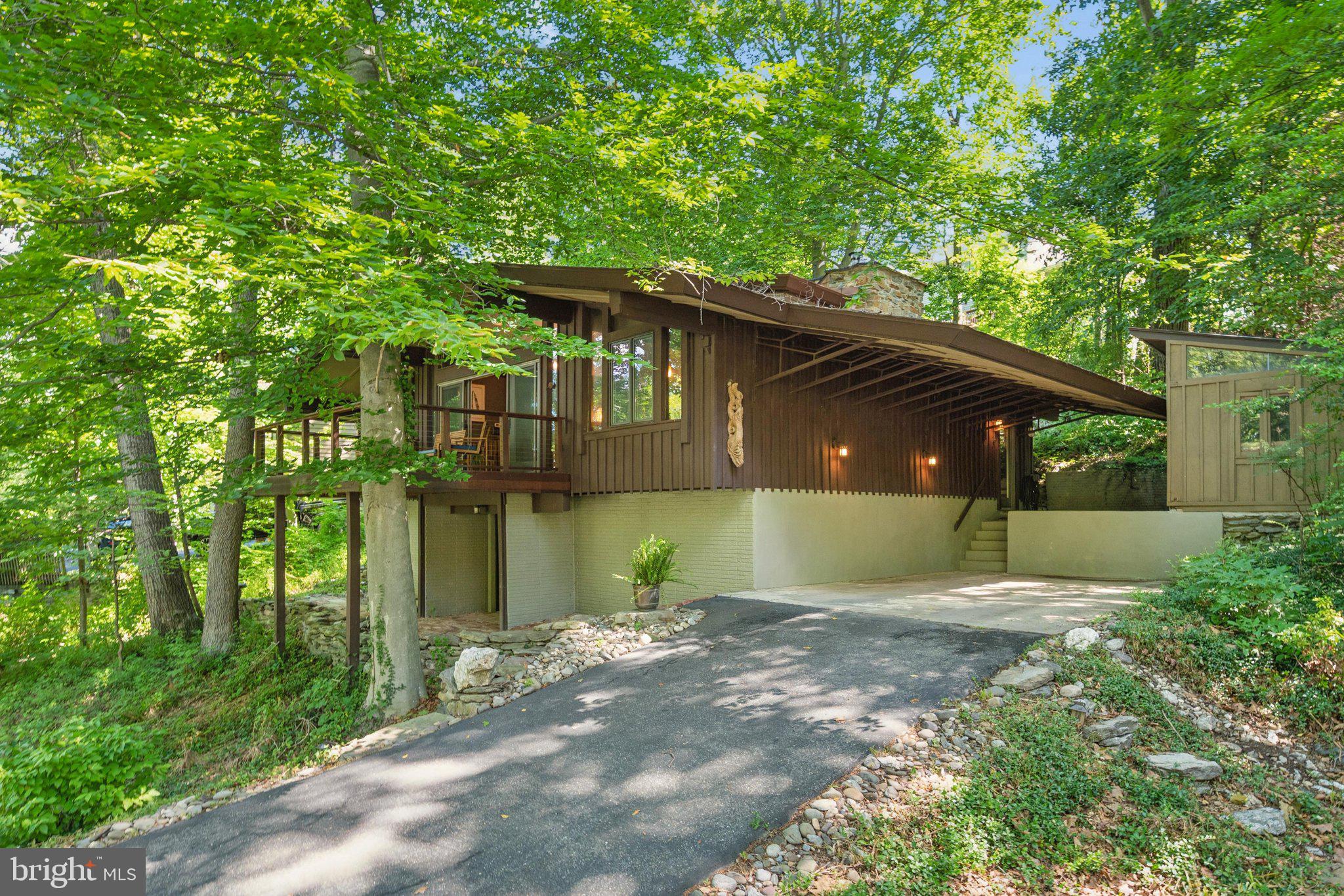 ***OWN A PIECE OF THE ORIGINAL LAKE LINGANORE VISION***ENJOY SEASONAL WATER VIEWS FROM THIS ABSOLUTELY SPECTACULAR DETACHED HOME DESIGNED BY E. FAY JONES, A FAMOUS ARCHITECT & APPRENTICE OF FRANK LLOYD WRIGHT KNOWN FOR DESIGNING STRUCTURES THAT BLEND WITH THEIR NATURAL ENVIRONMENT***RARELY DOES A HOME OFFER SUCH A REMARKABLE COMBINATION OF ARCHITECTURAL SIGNIFIGANCE & BEAUTY***THIS DISTINCTIVE CONTEMPORARY IS NESTLED AMONG MATURE TREES & THOUGHTFULLY POSITIONED TO EMBRACE ITS SURROUNDINGS***ENTERTAIN FROM A HIGH QUALITY IPE WOOD PLANK DECK WITH CABLE RAILINGS, THE PERFECT SPOT FOR GLIMPSES OF THE LAKE***INSIDE YOU'LL FIND SOARING VAULTED CEILINGS, DRAMATIC EXPOSED TRUSSESS, EXPANSIVE WINDOWS & WARM NATURAL MATERIALS THAT CREATE A SPACE THAT FEELS BOTH INSPIRING & INVITING***OPEN CONCEPT LIVING WITH A GREAT ROOM WITH BUILT INS, RICH HARDWOOD FLOORS & A STRIKING STONE FIREPLACE WITH WOOD STOVE THAT SERVES AS THE HEART OF THE HOME***THE UPGRADED KITCHEN FEATURES A HUGE ISLAND WITH SEATING, GRANITE COUNTERS, STAINLESS STEEL APPL'S, GLASS DOORS & CABINET LIGHTING***TWO BEDROOMS & FULL BATH ON THE MAIN LEVEL, WHILE A STUNNING SPIRAL STAIRCASE LEADS TO THE FINISHED LOWER LEVEL FEATURING THE 3RD BEDROOM & ADDITIONAL FULL BATH, WOOD PANELED WALL DECOR & BUILT IN BUNK BEDS***CARPORT & LONG DRIVEWAY WITH PLENTY OF PARKING***CINCH HOME WARRANTY***4 LAKES, 4 POOLS, 35+ MILES OF TRAILS, TOT LOTS, SPORTS COURTS, COMMUNITY EVENTS AND SO MUCH MORE***