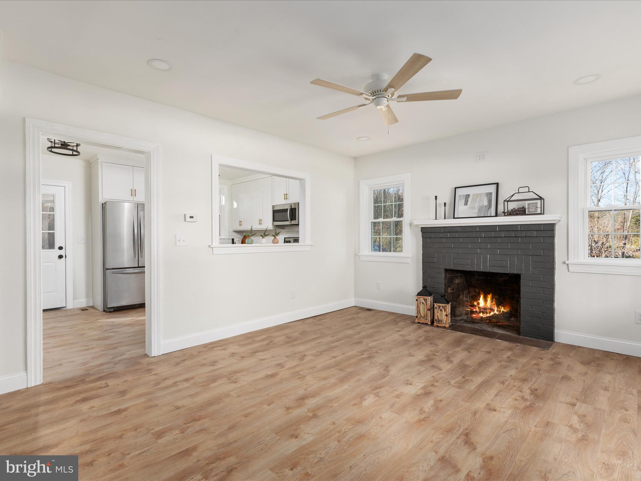 Beautifully remodeled Cape Cod home featuring 3 bedrooms and 2.5 bathrooms. The primary suite is conveniently located on the main level. The kitchen shines with granite countertops, stainless steel appliances, a tile backsplash highlighted by under-cabinet lighting, and white cabinets. Brand-new energy-efficient tilt-in windows provide natural light, while luxury vinyl plank flooring flows throughout the entire house. Enjoy cozy evenings by the wood fireplace with a mantle and brick hearth. Bathrooms include showers with custom-tiled walls, adding a touch of elegance. Additional updates include a brand-new roof and a main-level laundry room for added convenience. A NEW French drainage system added to help maintain a dry basement environment, ideal for future finishing & a newly revamped and approved conventional septic system!  Also, new stairs were installed for interior access to the basement.  Call today to schedule your private showing!