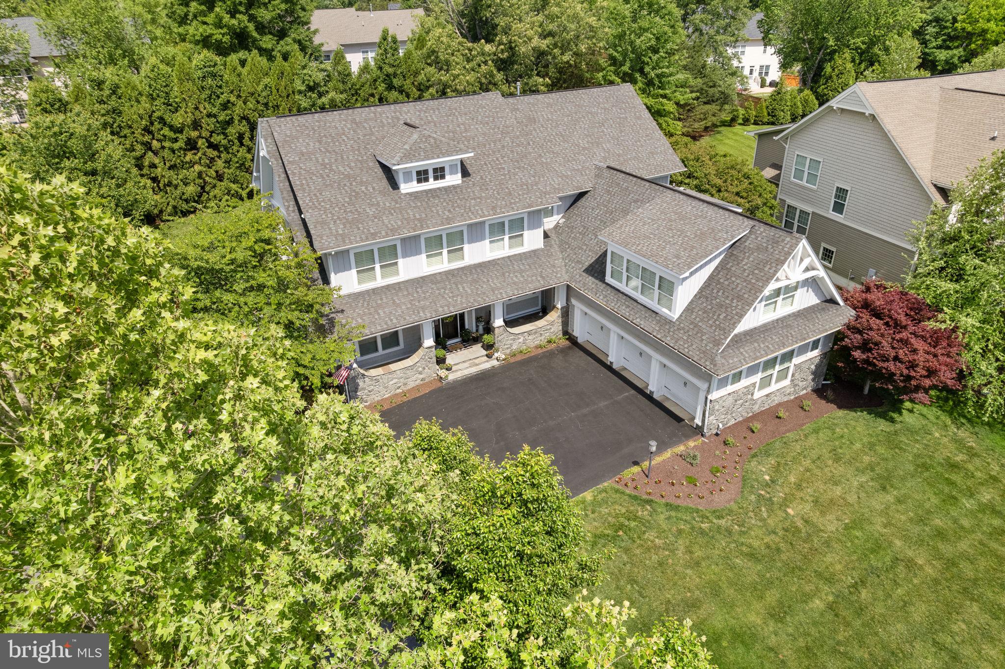 Welcome to an extraordinary custom residence where luxury, craftsmanship, and thoughtful design come together in every detail. From the moment you enter, you’ll notice the extensive hardwood flooring, elegant wainscoting, soaring ceilings, dual staircases, and countless high-end upgrades throughout.

Designed for both everyday living and entertaining, the gourmet kitchen is a true showpiece featuring a double island, double ovens, a coffee station connected directly to a water line, premium appliances, and a stunning stacked-stone accent wall in the breakfast area.

The adjacent flex room offers endless possibilities as a playroom, kids’ lounge, secondary office, expanded pantry, hobby room, or sitting room and features a striking custom brick accent wall. The spacious family room showcases extensive custom built-ins, a full-width mantle, additional decorative wainscoting, and large windows overlooking the private backyard.

The formal living room is highlighted by embossed textured wallpaper, a pearlescent plaster finish that beautifully reflects natural light, elegant crown molding, and a statement fireplace. The dining room offers a sophisticated Venetian plaster finish, custom deep-gray paint, a dramatic Restoration Hardware light fixture, and a bump-out that enhances both space and character.

Work from home in style in the private office featuring a custom built-in desk and cabinetry. Plantation shutters throughout the home add timeless elegance and privacy.

The luxurious primary suite is a private retreat featuring a sitting area, bump-out, electric fireplace, sophisticated metallic damask wallpaper, statement geometric lighting, and a spa-inspired bath with dual shower heads, a built-in television, and designer finishes throughout.

Upstairs, a private suite accessed by the secondary staircase offers exceptional flexibility as an in-law suite, guest retreat, au pair suite, or private living space.

The finished lower level is an entertainer’s dream featuring a dedicated theater room with reclining seating, a fully equipped custom bar with a copper countertop, beer refrigerator, refrigerator, ice maker, dishwasher, and sink, a game room, exercise room, custom wine storage with cedar plank ceiling, and even a hidden bonus room that adds a unique touch of character and intrigue.

Additional luxury features include integrated Sonos audio, security system, Tesla charging capability, electric pet fencing, multiple stone accent walls, several pre-wired television locations with outlets to hide wires, extensive custom storage in the mudroom, and countless designer details throughout.

Every space in this exceptional home has been thoughtfully curated to create a residence that is both elegant and highly functional—offering a rare opportunity to enjoy luxury living at its finest.