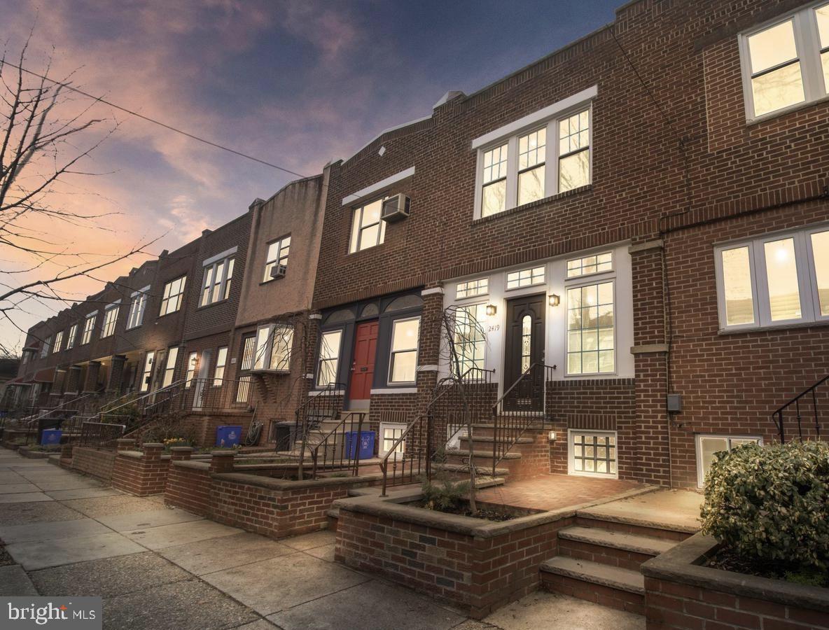 Welcome to the 2400 block of W. Ritner Street - an adorable tree lined street in Girard Estates that is filled with a good community of neighbors. Walk up your bricked front patio that is beautifully framed by two spring blossom trees. Pass through your front door and be welcomed by a bright sunroom with a brick accent wall and decorative repurposed barn doors from New Mexico. This is the perfect spot to be showered by morning sunlight while you enjoy a cup of coffee! Continue into the rest of your home and be wowed! The spacious living room is flooded with natural light and has a custom stacked stone accent wall. Beyond the living room, you'll pass by the dining area on the way to your updated kitchen. Your kitchen is well equipped with soft close cabinetry, new stainless steel appliances, new quartz countertops, and a timeless subway tile backsplash. You'll also find easy access to your private patio with a new custom wooden fence. Upstairs you'll find 2 large guest bedrooms that are currently being used as offices. Down the hall is the primary bedroom with copious amounts of closet space and lots of windows to add even more sunlight. In here you'll find a full bathroom with a tub/shower combo and a beautiful tile surround, linen closet, and because natural light is a theme of the home, there's a skylight. The basement is finished with a full bathroom and tile flooring. There's added storage under the staircase as well as in the oversized  mechanical closet - where you'll also find the washer and dryer. The home is ideally located to take advantage of the $250M happening in Quartermaster Plaza, easy access to 76 and 95, SEPTA, and iconic restaurants like Nick's Roast Beef and Philly South Philly Taproom. Come make this home yours!