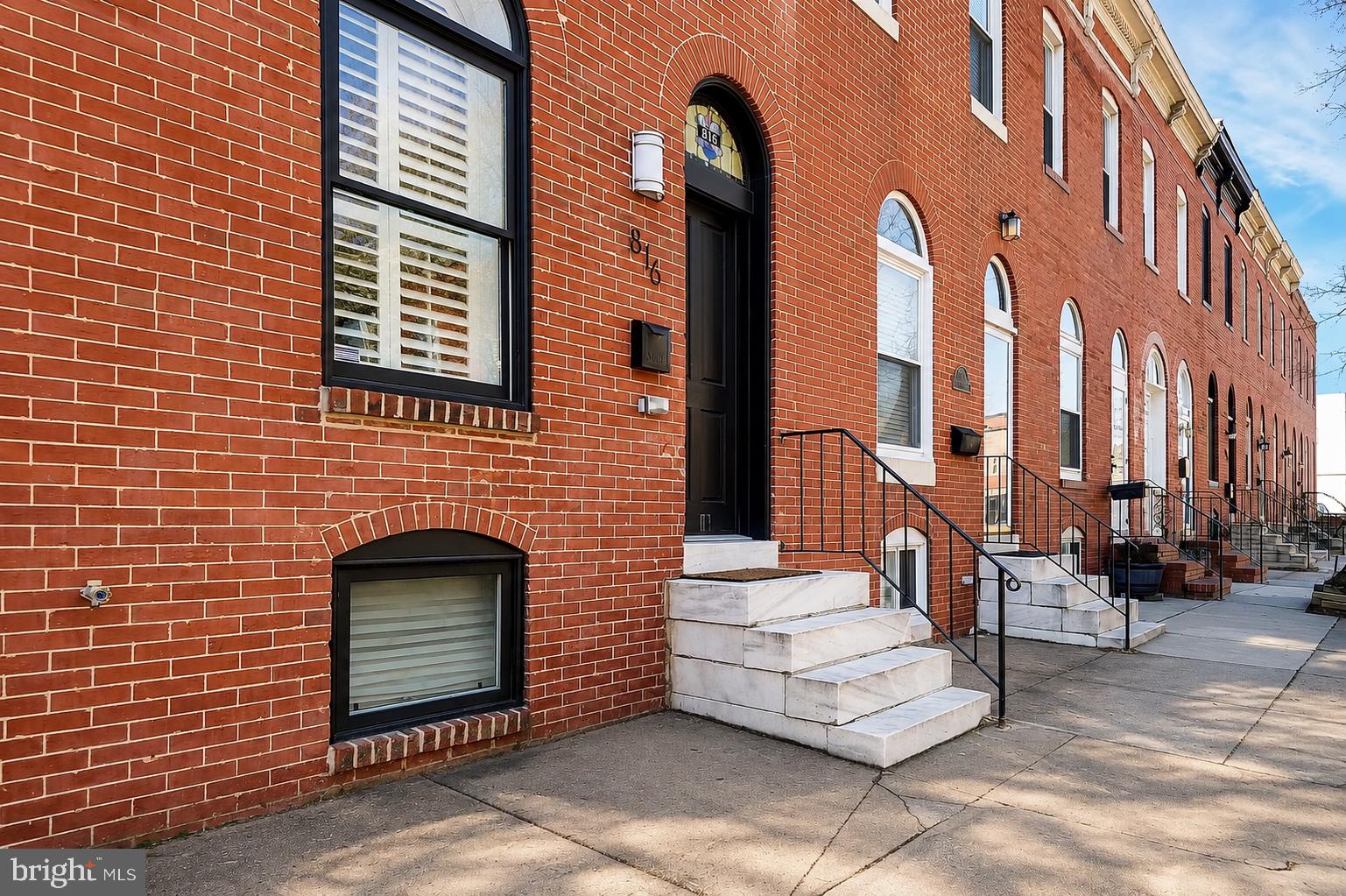 Beautiful 3-bedroom, 3-bath brick townhome in the heart of Canton, offering the perfect blend of charm and modern updates. Inside, you'll find hardwood floors throughout, exposed brick, coffered ceilings, crown molding, plantation shutters, and abundant natural light. The gourmet kitchen features granite countertops, stainless steel appliances, and plenty of cabinet space. The finished lower level includes a bedroom, full bath, and laundry area, making it ideal for guests or a home office. Upstairs, the spacious primary suite offers high ceilings, a luxurious en-suite bath with a double vanity and oversized walk-in rain shower. An additional bedroom includes its own full bath with a Jacuzzi tub. HVAC is 2012. Complete with a private rear parking pad and located just steps from Canton Square, Patterson Park, the waterfront, restaurants, and shopping, this home offers the best of city living.