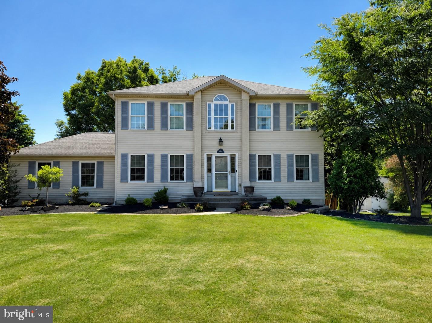 Welcome to 587 Weikel Road, an elegant and impeccably maintained residence offering timeless appeal, thoughtful updates, and exceptional indoor-outdoor living in one of Lansdale's most desirable neighborhoods. From the moment you step inside, you are greeted by a dramatic two-story foyer that sets the tone for the sophisticated yet comfortable lifestyle this home provides. Rich hardwood flooring extends throughout the main and upper levels, complemented by fresh neutral paint and quality finishes throughout. The spacious floor plan is designed for both everyday living and effortless entertaining, with beautifully proportioned rooms filled with lovely views of professionally designed landscaping on all sides of the home. At the heart of the home is the updated eat-in kitchen, featuring granite countertops, granite flooring, abundant cabinetry, and picturesque views of the spacious rear yard. Adjacent to the kitchen, the inviting family room offers a handsome fireplace and elegant French doors that lead to one of the property's standout features—an expansive covered deck overlooking the private backyard. Whether hosting guests or enjoying a quiet evening outdoors, this exceptional space seamlessly extends the living area beyond the walls of the home. Below, the walkout lower level opens to a stunning stamped concrete patio, creating a second outdoor entertaining area surrounded by mature landscaping. The finished basement offers valuable additional living space and includes a full bathroom, making it ideal for guests, a media room, fitness area, home office, or multi-generational living. The luxurious primary suite serves as a private retreat, featuring a beautifully appointed bath with his and hers sinks, travertine tile and granite countertops. Additional baths are enhanced with marble flooring, while the powder room showcases elegant granite flooring. Ceiling fans throughout all four bedrooms, as well as the living room, family room, and kitchen, provide year-round comfort. Discerning buyers will appreciate the home's extensive list of upgrades, including a whole-house generator, newer roof, newer windows, resurfaced driveway (2022), and over $20,000 in professional landscaping improvements completed in 2025. A charming custom shed provides the perfect combination of playhouse and storage space, while childproof-ready features add peace of mind.
Blending classic design, quality craftsmanship, and meaningful updates, this home offers a rare opportunity to enjoy refined living in a beautifully cared-for home where every detail has been thoughtfully considered. With its dramatic foyer, exceptional outdoor spaces, finished walkout lower level, and prime location, this is a home that truly stands apart.