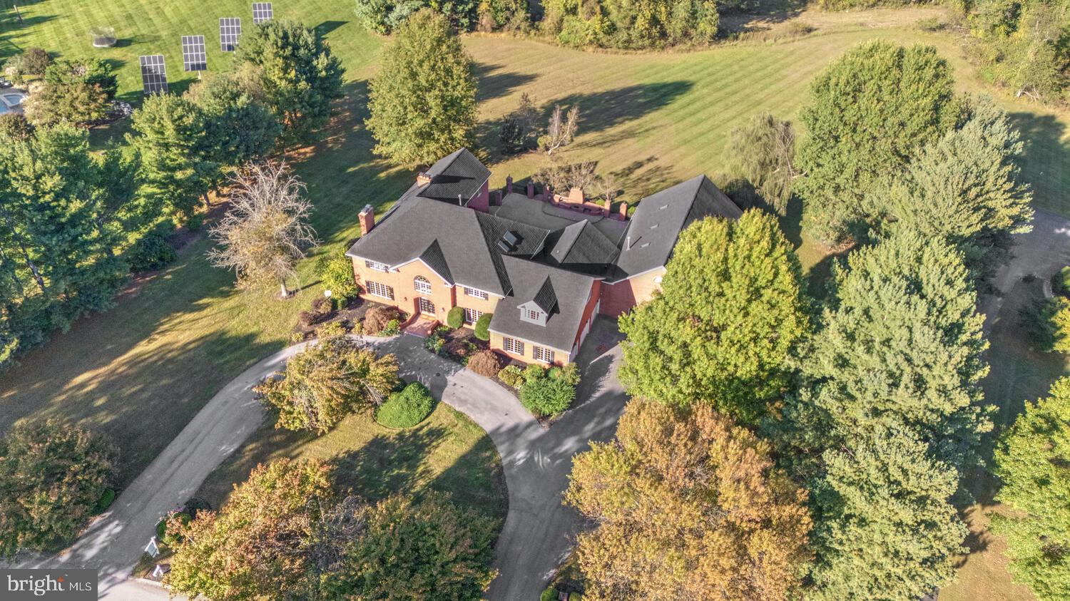 Experience the Majestic Grandeur of this Solid Brick Estate in the heart of Howard County, MD
This stunning all-brick estate, located at 13009 Twelve Tree Ct, Clarksville, MD 21029, offers an expansive living space of almost 11,000 square feet spread across all three levels. Set on a generous 3.10-acre lot near the end of a cul de sac, the home provides an incredible amount of privacy & space for both relaxation and entertainment. Built in 1989, this 35-year-old residence has been meticulously maintained, featuring recent updates that make it feel both modern & timeless. One of the highlights of the property is the large, heated indoor pool, measuring 20 x 40 feet and housed within a 40 x 60-foot room. Whether for swimming laps or simply lounging poolside, this feature offers year-round enjoyment, regardless of the weather. For vehicle enthusiasts or families with multiple cars, the large, three-car side-load garage provides ample parking and storage space. The home also features a circular driveway for easy access & additional parking. Outdoor spaces are equally impressive, with an extra large all brick patio surrounded by stately brick pillars & expansive views of the vast backyard, bordered by mature trees and a majestic weeping willow. With a large outdoor fireplace, grill & entertaining area, the patio offers ample space for outdoor dining & relaxation, with plenty of room to accommodate even the largest of outdoor gatherings with ease. The heart of the home is a sunny and open Gourmet eat-in Kitchen with multiple seating options including a large breakfast bar & table space for family or guests. Elegant white cabinetry offers plentiful kitchen storage options & is richly accented by high end Granite countertops & a custom backsplash. The kitchen provides direct access to the spectacular outdoor patio & the enclosed pool pavilion, making it ideal for effortless indoor-outdoor entertaining. A full bedroom & bath are located off the side of the kitchen as are the laundry area and direct entrance to the 3 car garage. A noted benefit of the home is a sloped brick ramp that leads from the main level bedroom/office area to the back patio for easy access to the patio & backyard areas for persons with mobility issues or those using a wheelchair or walker. With seven bedrooms & six-and-a-half bathrooms—many of which were renovated just five years ago—this home is well-suited for large families or those who frequently entertain guests. The interior boasts two fireplaces, adding warmth & charm throughout the home. The great room on the main floor is ideal for gatherings, with its open layout creating a welcoming atmosphere for friends & family. The great room, kitchen, bedroom & pool pavilion all feature direct access to the oversized patio, allowing the interior living areas to easily blend into the outside to seamlessly extend the useful living area of the home. In addition to the main Master Suite, which includes a sitting room & side balcony overlooking the vast backyard,  there is a second Master Bedroom, offering an additional private suite for guests. The property is further enhanced by a home office or library, providing a quiet space for work or study, and hardwood floors throughout the main & second levels,. The fully finished basement features a bonus room, full bathroom, multiple open recreation rooms & walkup stairs for easy access to the backyard. Additionally, this home benefits from a four-zone air conditioning system, ensuring comfort throughout the seasons. Additional updates include a six-year-old roof, recently updated air conditioning systems, & a new pool cover, ensuring peace of mind for the new owners. This home represents the perfect blend of luxury, comfort, and practicality, ideal for those seeking a spacious retreat in the heart of Howard County. Whether you are looking for a home to entertain guests, raise a family, or simply enjoy the finer things in life, this Clarksville property offers it all!