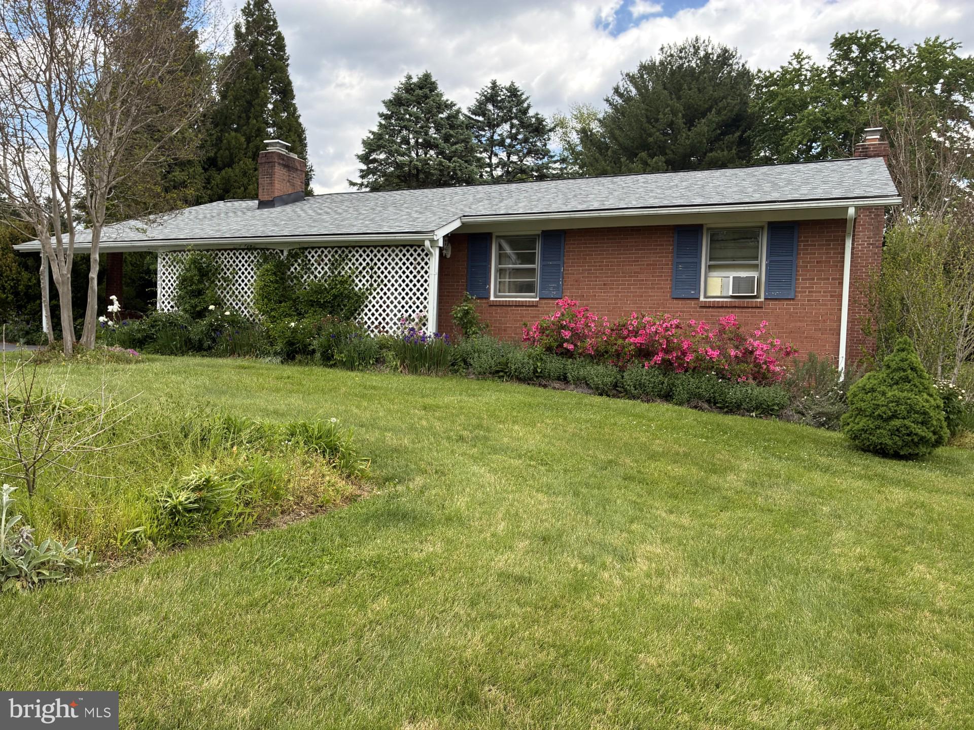New Price! Brick Rancher with 3 BR, 1 1/2 Bath on Lovely Landscaped Lot. Simplicity of 1 Floor Living.  Hardwood Floors on main level. Stackable Washer and Dryer in Kitchen. Gas Fireplace . 3 Spacious Bedrooms.  Lower level has lots of storage. Recently updated roof.  Duct work in attic for central air.  Tiled Basement floor with Woodburning  Stove.  Carport currently being used as a patio.  Beautiful Gardens with an abundance of Flowers that bloom from Spring to Fall.  Large Shed For all of  your Gardening Supplies!!  Being Sold AS IS!  Sellers are still packing.  Close to shopping , restaurants, parks and commuter Routes. Close to downtown Frederick!  Home Warranty! 24 Hour Notice! The Flowers are Blooming!!