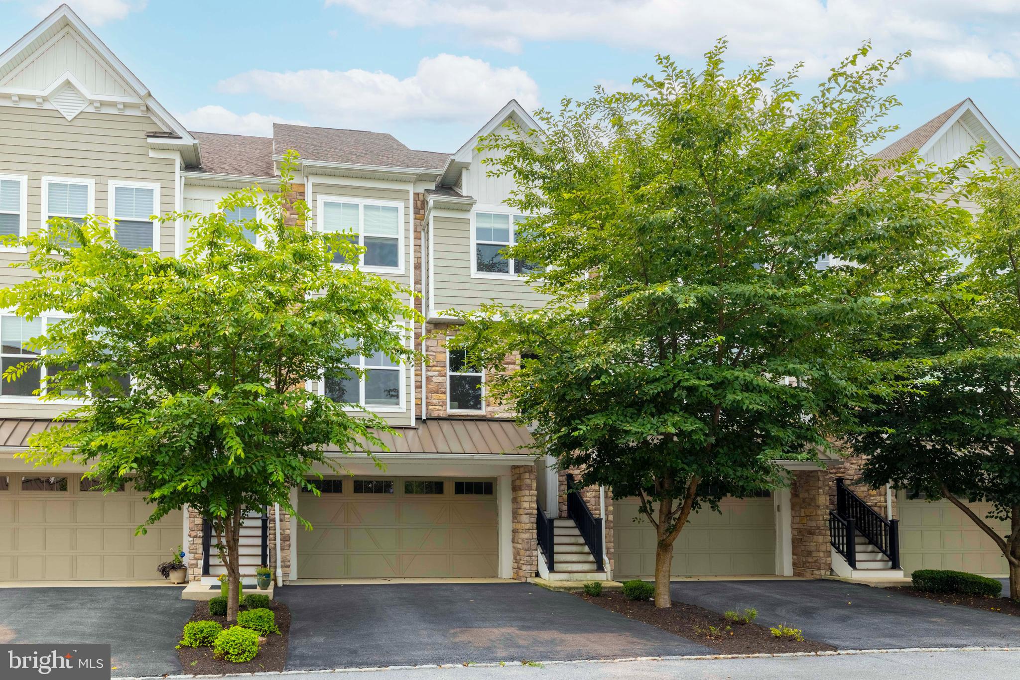 Thoughtfully designed and beautifully maintained, this sophisticated townhome in Reserve at West Goshen offers over 3,000 square feet of stylish living, an exceptional floor plan, and one of the community's most distinctive features—a private three-stop elevator providing effortless access to every level. Whether appreciated today as an everyday luxury or valued for the long-term convenience and accessibility it offers, this rare amenity sets the home apart. Built in 2019 and enhanced by its current owners with tasteful designer touches, the home blends timeless finishes with comfortable everyday living. Step inside to discover soaring 9-foot ceilings, rich hardwood flooring, abundant natural light, and an open-concept main level designed for both entertaining and daily life. The gourmet kitchen serves as the heart of the home, featuring quality cabinetry, stone countertops, premium appliances, generous workspace, and an oversized island that naturally gathers family and friends. The adjoining dining area and spacious great room create an effortless flow for entertaining or simply unwinding at the end of the day.  Upstairs, the expansive primary suite offers a true retreat with an extended sitting area, two walk-in closets, and a beautifully appointed ensuite bath. Two additional bedrooms, a full hall bath, and a conveniently located laundry area complete the upper level.
The finished lower level provides remarkable flexibility to suit your lifestyle. Whether envisioned as a home office, media room, fitness studio, guest suite, or fourth bedroom, this versatile space adapts effortlessly to your needs while offering seamless walk-out access to the attached two-car garage. With elevator access extending to all three levels, every space in the home is equally convenient and accessible. Perfectly positioned within the award-winning West Chester Area School District, Reserve at West Goshen places you less than three miles from the vibrant shops, restaurants, and entertainment of downtown West Chester. Commuters will appreciate the home's convenient location just off West Chester Pike with quick access to Route 202, while Target, grocery stores, parks, and everyday conveniences are only minutes away. Offering the ease of newer construction without the wait, this exceptional residence combines sophisticated design, low-maintenance living, and an outstanding location in one of Chester County's most desirable communities. Homes offering this combination of space, style, and the rare luxury of private elevator access are seldom available. Schedule your showing TODAY!