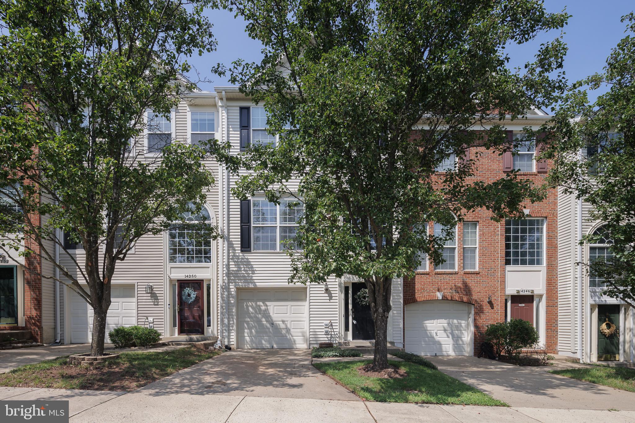 Open House Saturday July 25th 1-3pm*Welcome to this beautifully maintained one-car garage townhome, ideally located directly across from Harris Teeter and backing to a peaceful tree-save area, offering both everyday convenience and a private natural setting. Fresh neutral paint and a dramatic two-story foyer with ceramic tile flooring create a warm and inviting first impression. The walk-out lower level features an expansive recreation room perfect for entertaining, relaxing, or creating a home office or fitness space. A full bath rough-in provides an excellent opportunity for future expansion, while multiple storage rooms offer exceptional organization. Wide staircases throughout the home enhance the spacious feel. The main level is designed for comfortable living and entertaining, highlighted by a large family room with a stylish accent wall and a conveniently located powder room. The spacious eat-in kitchen is sure to impress with white cabinetry, ceramic tile flooring, stainless steel appliances, a cooktop, and a center island with a sink—ideal for home chefs and gathering with family and friends. Step outside to the oversized deck overlooking mature trees, where afternoon shade creates the perfect setting for outdoor dining or unwinding after a long day. Upstairs, the vaulted primary suite offers a relaxing retreat complete with a large walk-in closet and a beautifully renovated spa-inspired bath featuring a standalone soaking tub, separate shower, and dual vanities. Two generously sized secondary bedrooms share a well-appointed hall bath, and the conveniently located upper-level laundry room makes everyday living effortless. Combining thoughtful updates, generous living spaces, abundant storage, and a prime location, this exceptional townhome is the perfect place to call home.