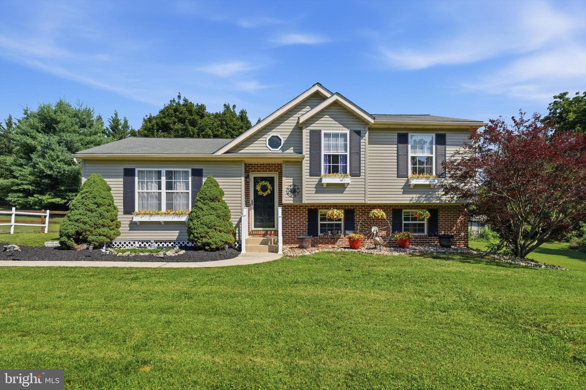 Peaceful country living meets everyday convenience on this beautifully maintained 1.11-acre property just outside historic Union Bridge in Carroll County. Backing to picturesque farmland and located within an hour of Baltimore, this inviting multi-level single-family home offers the perfect blend of privacy, space, and accessibility. Built in 1994, this 3-bedroom, 1.5-bath home has been thoughtfully prepared for its next owners. Recent updates include fresh interior paint, brand-new carpeting throughout the bedroom level, an updated primary bathroom, exterior power washing, and a freshly painted foundation—making this home truly move-in ready. The main living area features durable luxury vinyl plank flooring, a soaring cathedral ceiling, and a separate dining room with glass french doors leading to the expansive fenced backyard, ideal for entertaining, gardening, pets, or simply enjoying the peaceful rural setting. The finished lower level family room provides valuable additional living space, making it perfect for movie nights, a playroom, or a home office. A sliding glass door offers access to the backyard, seamlessly extending your living space outdoors. The unfinished lower level provides abundant storage space and offers a rough-in for a future third bathroom, giving you the flexibility to expand as your needs evolve. Whether you’re looking for room to roam, scenic country views, or a home that’s been refreshed and ready to enjoy, this property checks all the boxes. For added peace of mind, the seller is including a one-year home warranty for the lucky new owners.