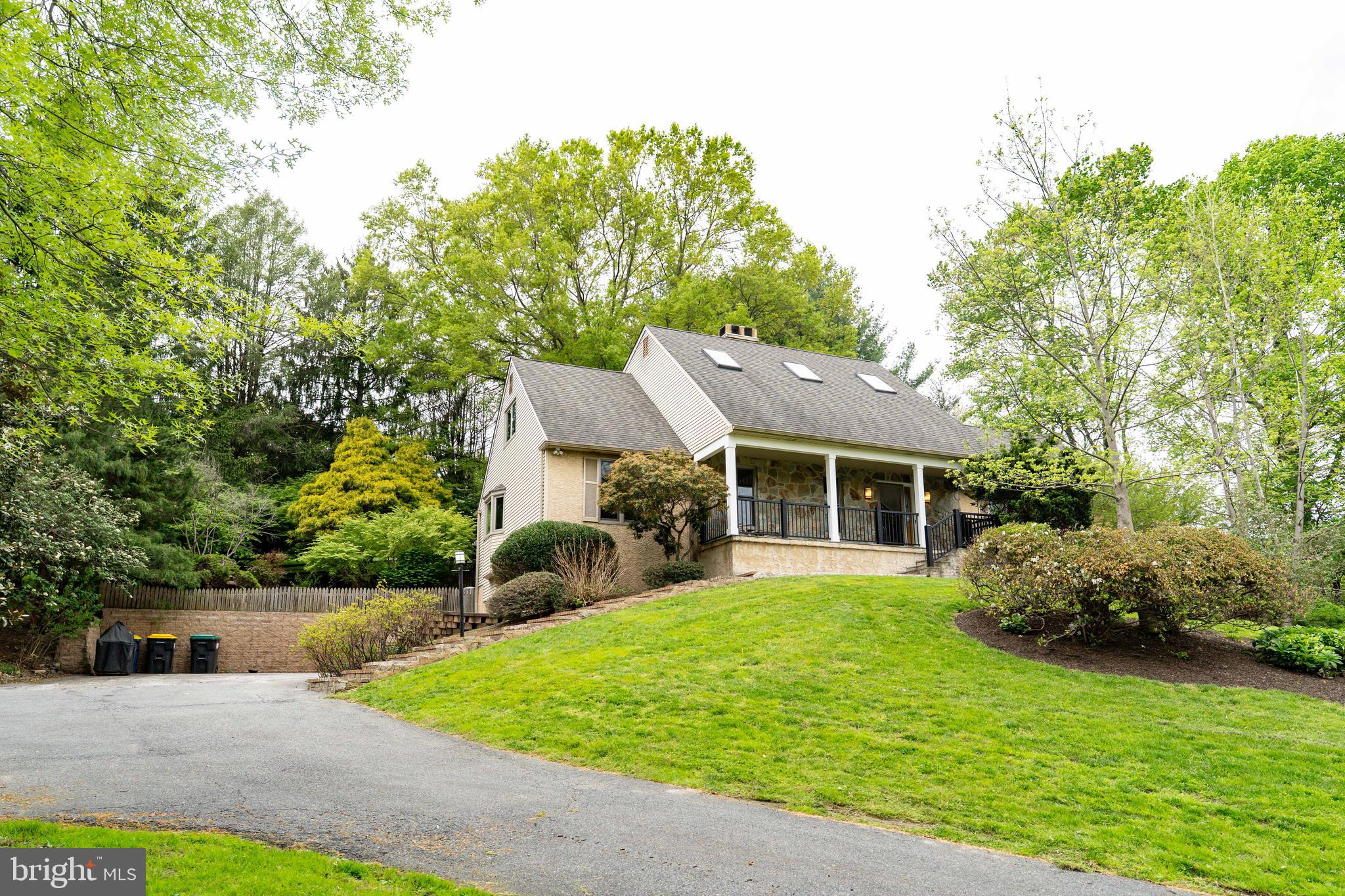 ​Welcome home to this stunning natural retreat, conveniently situated just minutes from several parks and scenic walking trails in Pike Creek. As you make your way up the driveway, you’re greeted by this expansive Cape Cod-style home—offering timeless charm, exceptional space, and a setting that truly feels like a private getaway every time you arrive. Upon entering, a grand foyer with vaulted ceilings and beautifully refinished hardwood floors extend throughout the first level. The step-down living room offers a warm and inviting atmosphere, highlighted by a quaint wood-burning fireplace. Flowing seamlessly, you’ll find a spacious dining room ideally positioned just off the kitchen. Designed with entertaining in mind, the kitchen offers an impressive layout featuring a large island, generous space for a substantial dining table, a wet bar with a beverage refrigerator, an abundance of granite counter space and cabinetry for ample storage. Just off the opposite side of the kitchen, a spacious three-season room awaits, featuring tile flooring and offering a serene setting to relax while taking in the beautiful natural views of the backyard. A conveniently located half bath is also situated off the kitchen, adding to the home’s thoughtful layout. The home offers a highly desirable first-floor primary suite that truly has it all. Featuring beautiful hardwood floors, the suite also includes a comfortable sitting area, creating the perfect private retreat. You’ll find an impressive walk-in closet with custom shelving, an additional walk-in closet for added convenience, and a spacious primary bath complete with two sinks, a soaking tub, heated floors and a beautifully tiled walk-in shower. Moving upstairs, you’ll find four additional generously sized bedrooms, offering plenty of space and versatility. This level is completed by a fully renovated bathroom featuring dual sinks, a jet soaking tub and shower combination, and a skylight that fills the space with beautiful natural light. The fully finished basement offers exceptional additional living space, complete with a kitchenette area featuring a beverage refrigerator, sink, microwave, and cabinetry for convenient storage. This level also includes a walk-in closet and a full bathroom with a stall shower, making it an ideal setup for guests, in-laws, or flexible multi-purpose living. But that’s not all—the true highlight of the home is the private backyard oasis. Designed for relaxation and entertaining, it features a spacious deck, hot tub, retractable awning, and a cozy fire pit area, all perfectly suited for enjoying late summer evenings and peaceful nights under the stars. This home also features a variety of thoughtful updates, including energy-efficient geothermal heating, newly installed Renewal by Anderson windows, fresh paint throughout the first floor, new front porch railings, and numerous additional improvements that enhance both comfort and appeal. Ideally located near a variety of dining, shopping, and entertainment options, this home offers both convenience and lifestyle. With its exceptional features and desirable setting, it is sure to attract attention and will not last long.