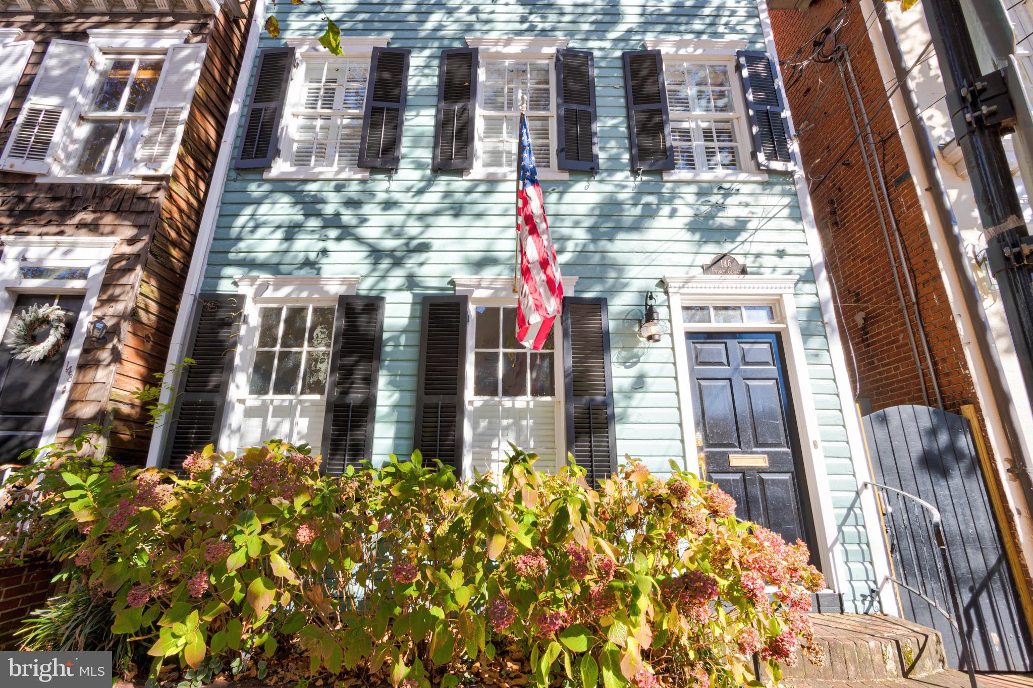"Price Improvement..." Own a Piece of Annapolis History – Don’t miss this rare opportunity to own an exquisitely restored historic home in the heart of downtown Annapolis. Welcome to The Quarter Deck on Prince George—a 4-bedroom, 2.5-bathroom retreat that blends timeless charm with modern convenience, all while boasting a proven short-term rental history. Financials are available upon request. This is the perfect opportunity for buyers looking to live in downtown Annapolis or they have a 1031 and need a quick move!

As you approach, you're welcomed by vibrant hydrangeas framing the elegant exterior. Step inside to discover brand-new gleaming hardwood floors flowing through the foyer, living, and dining rooms, setting the stage for a refined yet welcoming atmosphere. The grand entryway captivates with stately columns leading into a spacious living room bathed in natural light. At its heart, a stunning double-sided brick fireplace seamlessly connects the living and dining rooms—creating the perfect ambiance for intimate gatherings or cozy evenings by the fire. Step into a chef’s dream kitchen—fully equipped and thoughtfully remodeled to blend style and functionality seamlessly. Featuring elegant granite countertops and sleek stainless steel appliances, including a gas range, dishwasher, and spacious refrigerator, this kitchen is designed for both everyday ease and culinary creativity. Whether you're preparing a gourmet feast or a quick bite, this beautifully updated space makes every cooking experience effortless and enjoyable. From the kitchen, step outside into your fully fenced private backyard oasis—a serene retreat perfect for relaxation and entertaining. Whether you're sipping your morning coffee, hosting a summer barbecue, or unwinding under the stars, this inviting outdoor space offers the perfect blend of privacy and charm. Make your way up to the second level, where comfort and convenience await. This thoughtfully designed space features two beautifully appointed bedrooms, a spacious family room perfect for relaxing or entertaining, a fully renovated full bath with modern finishes, and a dedicated laundry room for added convenience. Whether you're unwinding after a long day or gathering with loved ones, this level offers the perfect blend of style and functionality.  Head up to the third level and prepare to be impressed. The expansive primary bedroom sits at the front of the home, bathed in abundant natural light, creating a bright and inviting retreat. Just steps away, indulge in the spa-like bathroom, complete with modern finishes designed for ultimate relaxation. A fourth bedroom completes this level, offering comfort and versatility to suit your needs. With its rich character, unbeatable location, and inviting warmth, this home is more than just a place to live—it’s a true Annapolis experience. 

Don't miss the opportunity to own a beautifully restored historic gem, just steps from the U.S. Naval Academy, City Dock, Ego Alley, and the vibrant shopping and dining scene along Main Street. Schedule your private tour today!