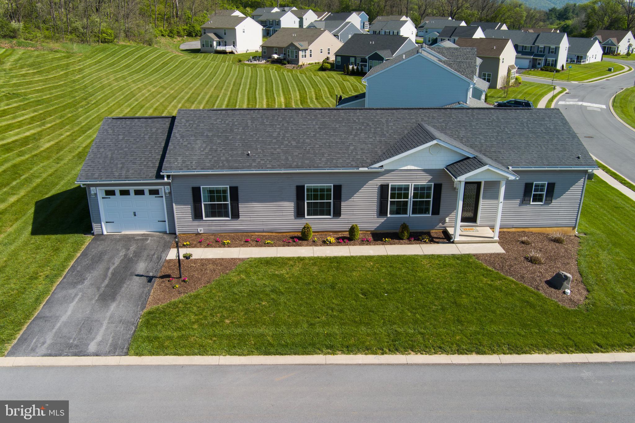 OPEN HOUSE Sunday May 31, 2026 from 11:00-1:00. 

Skip the builder wait and move in now — this move-in ready ranch in the Village of Nittany Glen is priced well below new construction in the same neighborhood, with no builder timelines or surprises. The single-story home features an open-concept floor plan with a large kitchen island, stainless steel appliances, and pendant lighting. French doors open directly to a private custom paver patio — your own outdoor entertaining space. The primary suite includes a shiplap style accent wall, dual-vanity en-suite bath with walk-in shower, and dedicated dressing area with built-in storage. An attached 1-car garage with interior access and extended driveway parking complete the home. Residents enjoy a clubhouse, seasonal outdoor pool, fitness room, and picnic area — all covered by the condo association along with exterior maintenance, lawn care (mowing & mulching the front of the house every other year), and trash. Minutes from Penn State, University Park Airport, and North Atherton Street dining and retail. Schedule your private showing today!