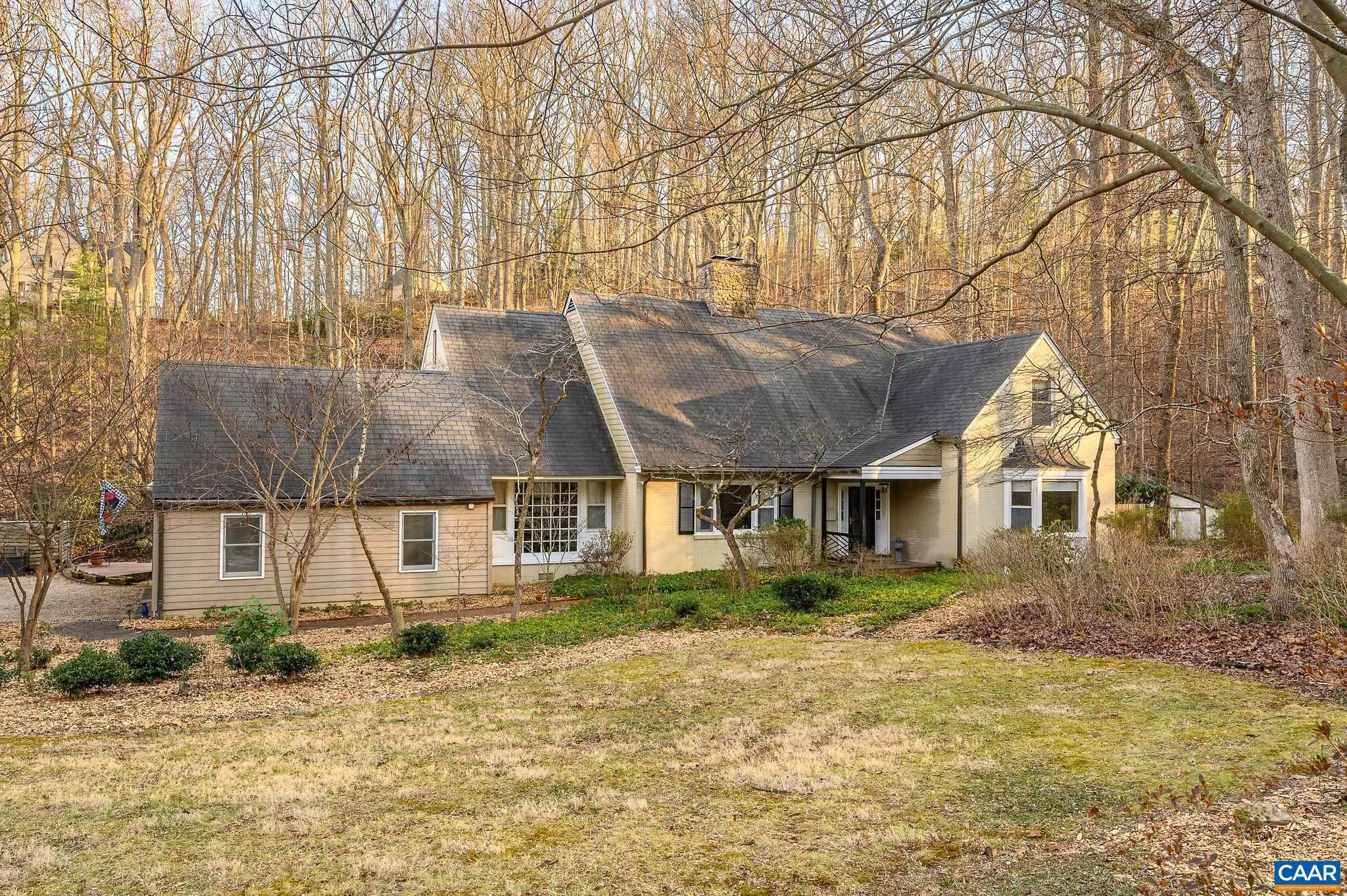 A Rare offering in Ednam Forest. Over two park-like acres and timeless curb appeal offer a balance of both privacy and neighborhood living. Sunny yard with meandering stream and an abundance of perennials, flowering shrubs and trees. Large rooms, 9 ft. ceilings, hardwood floors and a flexible floorplan allow for formal and informal spaces. Private first floor primary bedroom suite with separate office or small bedroom is completely separate from the public spaces. The spacious entry foyer provides great flow to the living room and den each with fireplace. Den with extensive built-ins opens to four season sunroom with access to the large deck, private hot tub area. The kitchen has a mudroom/laundry room entry off 2 car attached garage. The second floor has 3 additional bedrooms and multi-purpose space for a library/ game room, and a full bath. Abundant storage spaces and closets inc. third floor walk in storage room with cedar closet. Hightec synthetic Slate roof, plus copper roof for the Sunroom. Oversized copper gutters, Hardiplank siding and a propane, whole house generator. Walk to the Boar's Head Sports Club, Birdwood Golf Course and Rivanna walking trails. Murray Elementary, Henley Middle School and Western School district.,Fireplace in Family Room,Fireplace in Living Room