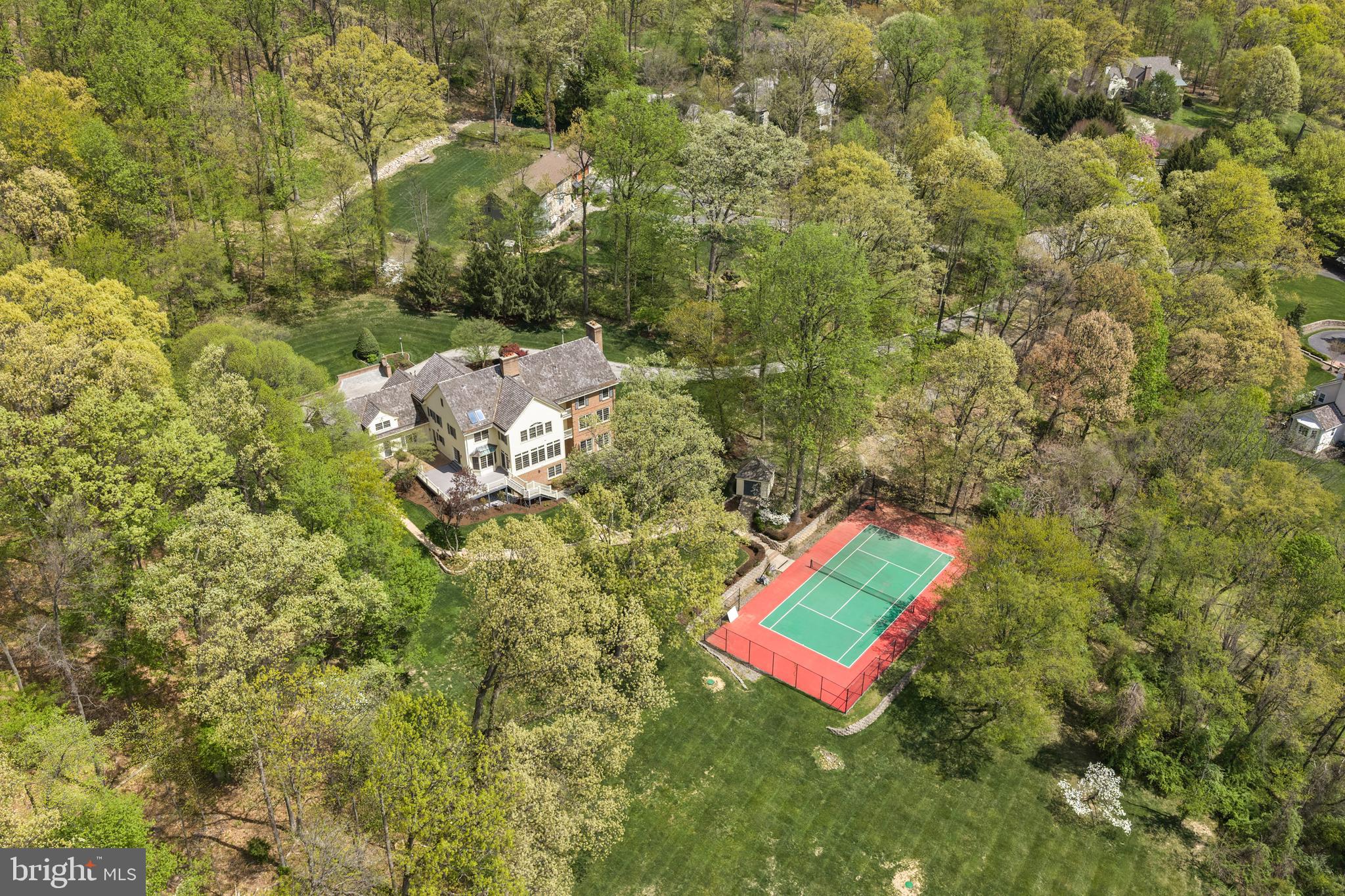 OPEN HOUSES CANCELLED. Welcome to 2062 General Alexander Drive, an exceptional custom-built residence gracefully positioned at the top of a cul-de-sac in the highly acclaimed Tredyffrin-Easttown School District. This home captures breathtaking, long-range views and offers a rare sense of privacy and serenity just moments from historic Valley Forge National Park. The stunning sweeping vista is extraordinary and is appreciated out of almost every window. Set on nearly three lush acres, the grounds are framed by mature greenery and stunning specimen plantings that create a private, estate-like setting. A personal tennis court offers flexibility for a variety of uses, easily serving as a sport court or pickleball court to suit your lifestyle.  This distinguished five-bedroom, four-and-a-half-bath home showcases timeless architecture with a stately brick and siding exterior, blending classic elegance with modern comfort. Thoughtfully designed living spaces feature generous proportions and a seamless flow ideal for both everyday living and larger scale entertaining. Four fireplaces are placed throughout the home, adding warmth, ambiance, and character to multiple living spaces. Offering approx. 6000+/- sq ft of finished living space on three floors, there is ample room for everyone. Enter the graceful front Foyer with elegant curved staircases leading to the upstairs as well as to the finished Lower Level. This center hall includes a convenient closeted wet bar for entertaining and a balcony to enjoy the view. Formal living and dining rooms are light filled and flank the foyer. The family room offers a brick fireplace, a wall of windows to fully appreciate the remarkable landscape and door leading to the oversized composite deck. An eat in Kitchen with large breakfast room provides a center island, abundant cabinetry and access to a large laundry and utility room with backstairs up to the extensive bedroom suite. A conveniently located powder room completes this well-designed level. Upstairs, the spacious primary suite boasts a tray ceiling, fireplace, bathroom with soaking tub and stall shower and a large walk-in closet-all while overlooking the gorgeous views. Two additional bright bedrooms share a Jack & Jill bathroom. The 4th bedroom has direct access to another full Bathroom. Last, but not least, is an extensive bedroom with its own interior and exterior access with a small kitchenette and sitting area. This bedroom is wonderfully suited as in-law or nanny suite. A walk-up third floor presents tremendous potential-currently unfinished, this expansive space offers an exceptional opportunity to create additional living areas. The fully finished walk-out lower level provides incredible versatility-perfect for recreation, fitness, and home office. Also including a full Bathroom, a wet bar, walk in wine storage room and fireplace, entertaining on this floor is seamless. Multiple doorways lead one to the patio to enjoy the bucolic views and to watch games on the tennis court. Additional highlights include an oversized three-car garage, extensive driveway parking and great indoor unfinished storage space. New windows and French doors were installed in 2020, HVAC systems all up to date and the septic was inspected and in good order providing the new homeowner with piece of mind. The “fun stuff” is left should one want to customize to their taste. With super proximity to Paoli Amtrak Station and major arteries commuting is a breeze from this location. Enjoy the local parks, outdoor recreational venues and wonderful dining and shopping just a stone’s throw away. A rare offering that combines custom craftsmanship, scenic beauty, and an unbeatable location, 2062 General Alexander Drive is a refined Main Line retreat. Schedule your tour of this truly special property today.