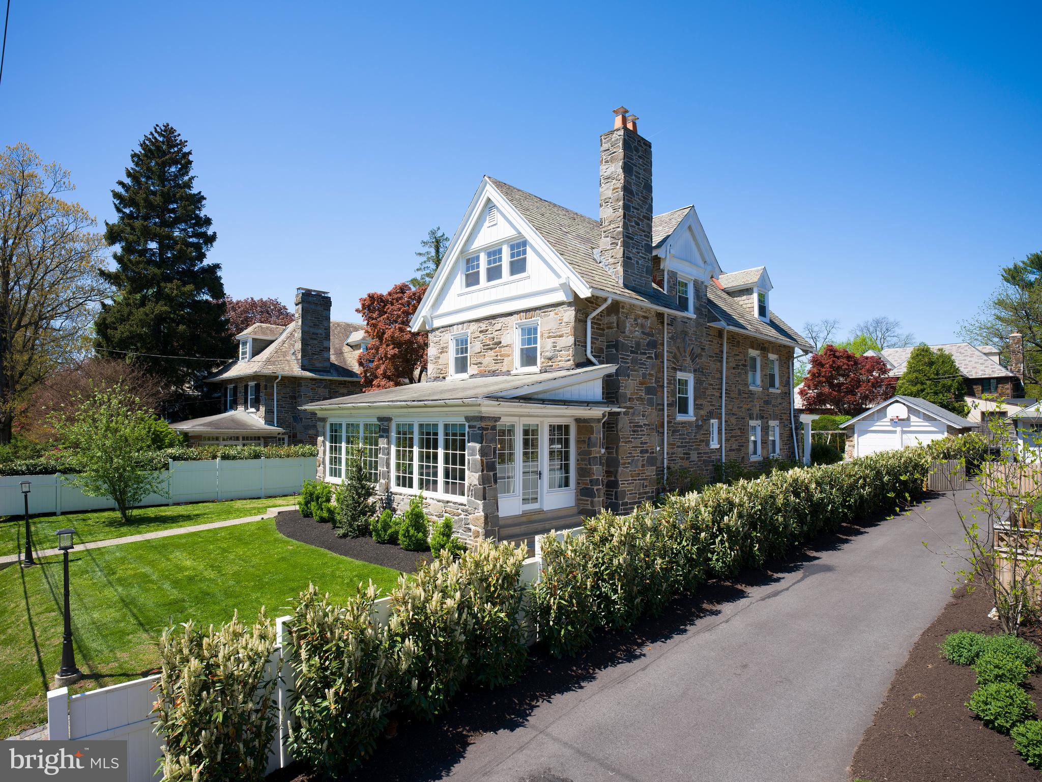 319 North Bowman Avenue is a classic stone Colonial in the heart of Merion Station, thoughtfully updated while preserving the scale, craftsmanship, and warmth that define Main Line architecture of this era. Set on a level quarter-acre along a quiet, tree-lined street, the home offers over 100 years of character paired with meaningful improvements completed throughout the past decade. Natural light fills the home from morning through evening. The welcoming foyer opens to generously proportioned living and dining spaces designed for both everyday living and entertaining. The family room, updated with custom Marvin windows in 2024, overlooks the private rear yard and serves as a bright central gathering space. The kitchen features cherry cabinetry, granite countertops, a five-burner gas cooktop, new double wall ovens and dishwasher installed in 2025, and ample space for casual dining and a work area. Beyond the kitchen, the flat rear yard is framed by mature landscaping, with new walkways and refreshed plantings completed in 2023. Upstairs, the primary suite includes a sitting area and private bath, while the third floor offers three additional bedrooms and a full bath, providing exceptional flexibility for guests, offices, or growing households. The fully finished lower level was rebuilt in 2024 with French drains, Drylock waterproofing, and sump pumps, creating substantial additional living space ideal for a gym, playroom, media room, or studio.

Additional improvements throughout the home include updated bathroom fixtures and finishes in 2025, refinished and repainted radiators, updated lighting throughout, custom window treatments, and significant system and infrastructure upgrades that allow the home to live comfortably while maintaining its original architectural character.. One of Merion Station’s most appealing qualities is its walkability. Merion Elementary, the Merion SEPTA station, Narberth’s shops and restaurants, Saint Joseph’s University, and the Barnes Arboretum are all nearby. Located within the highly regarded Lower Merion School District, the home is served by Merion Elementary, Bala Cynwyd Middle School, and Lower Merion High School. A rare opportunity to own a gracious stone Colonial with space, character, meaningful updates, and a location that truly supports everyday Main Line living.