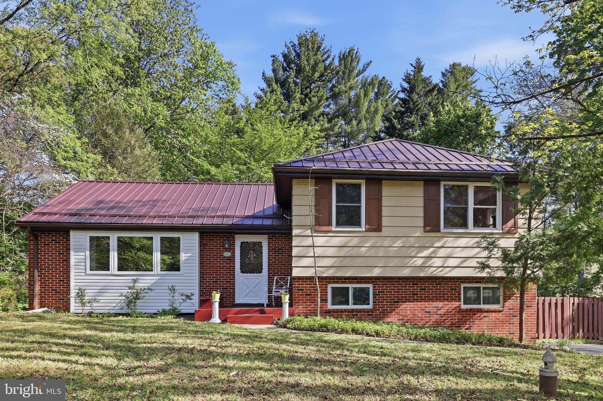 A rare availability (for a limited time) and a great value in this sought-after neighborhood. Why pay for a townhome and HOAs, when you can have this easy-to-maintain solid efficient single-family home with low taxes, ideal for healthy, peaceful living in Longwood Estates, a safe established community in the Chadds Ford area, and home to top-ranked school districts. In addition, this home offers several valuable remodeled features not found in many nearby properties:  1. Connected to natural gas and municipal water, not common in the area (a $30,000 value). Well water is still available too; 2. New metal roofing installed in 2023 (a $25000 value), known to last for $70+ years, 2-3 times the lifespan of asphalt shingles; 3. Insulated and heated sunroom with 360-degrees of premium wooden-frame Pella windows, with utility as an area for work, study, play, exercise or host guests (A $30,000 value); 4. Fully finished lower level with a ping-pong table (optional to keep) which can also be used for storage, or as a guest or game room. There is direct access to the garage which offers additional crawl-space storage, or workshop opportunities; 5. Chemical-free landscape (0.7 acres) with young organic fruit trees, safe for people, pets and gardening. Sellers have never sprayed the land or trees with any pesticides or chemicals so it is completely non-toxic for pets or others playing in the yard and for planting/gardening; 6. A large, private and peaceful backyard with mature and locally significant specimen trees such as Sugar Maple, Walnut, White Pine, Cedar, Hemlock, and Persimmon fruit trees, and a small fenced area containing a play set and ideal for recreation, pets/chickens; 7. Chemical, and pet-free living areas inside: Only non-toxic cleaners used and shoes always removed prior to entering, leaving the hardwood floors in good shape; 8. The 3rd bedroom upstairs is currently fitted with an ergonomic home office or study room with premium solid, cherry desk space that offers cabinet space as well as bookshelves.  This home, situated away from the road, faces a large wooded estate and not crowded busy commercial or residential developments. The large front casement window opens to a beautiful cross view of trees/nature.  Other attractive features include: Quality hardwood floors and beautiful natural light coming through the large living room window, beautiful oak cabinets and granite countertops in the partially open kitchen, ideal for food preparations or breakfast conversations without disturbing other rooms. Directly next to the kitchen is the dining room which makes it easy when hosting holidays or game nights. Upstairs is where you will find three (3) bedrooms with matching hardwood floors and numerous closets, and a full bathroom with a window.  You have the option to keep some furniture items and fixtures if it saves you time and money on your move and initial furniture purchase. This house is only minutes from the world-renowned Longwood Gardens and the Brandywine Valley region, and allows easy access to shops and restaurants (in Kennett Square or Wilmington), Rt 52, Rt. 1, Philadelphia and nearby towns in Maryland.  Bidding, Offers and Timeline: The listed price is a suggested bid.  All bids/offers received throughout the week are reviewed on the following Tuesday (ONCE EVERY TWO WEEKS), and sellers reserve the right to either accept/negotiate a best offer (value and terms), or continue the listing/showing.