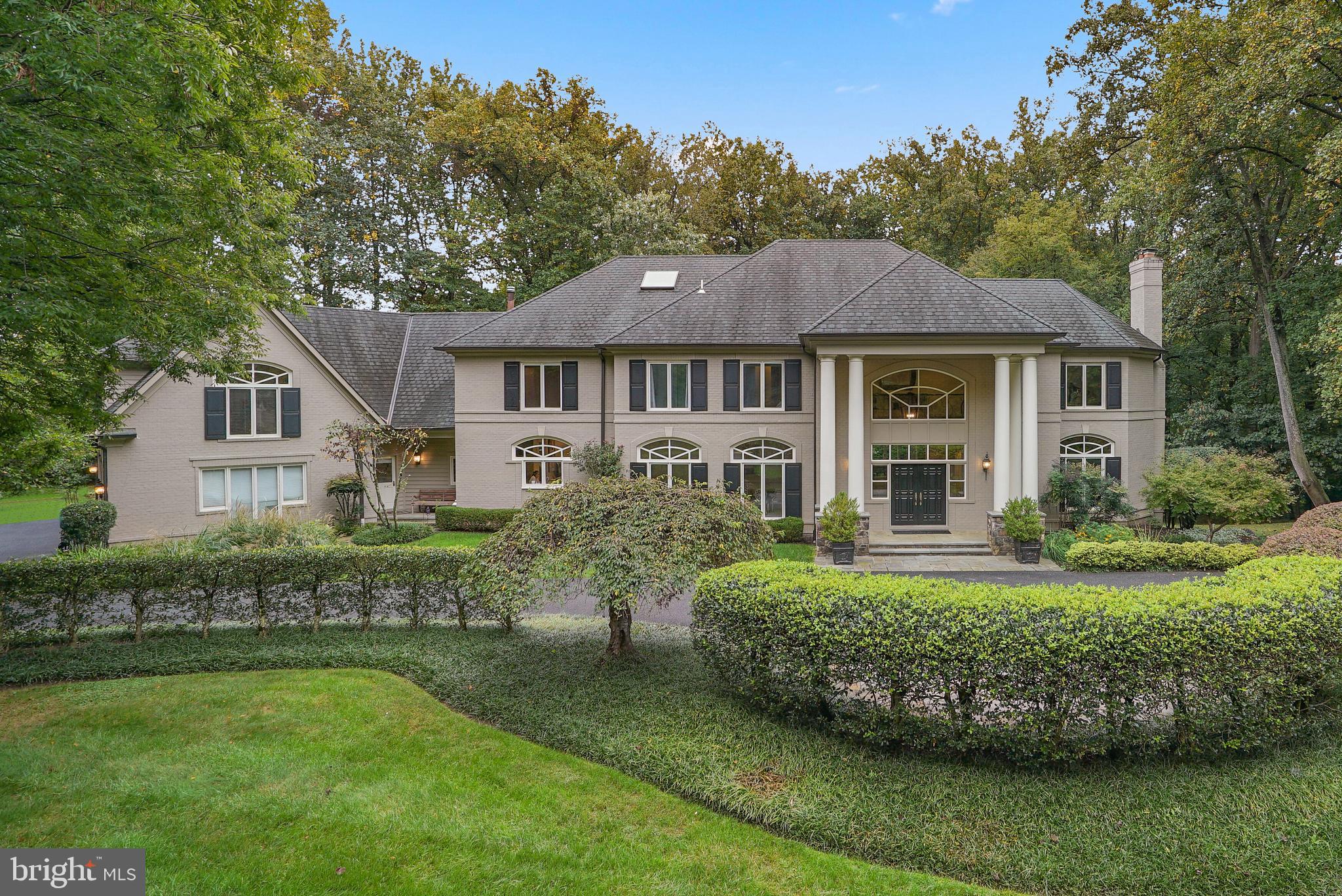 Custom-built transitional home sited on a private 2-acre cul-de-sac lot with country club amenities including a tennis court, swimming pool with spa & in-home sauna is surrounded by mature trees & specimen plantings. A circular drive & covered portico invite you into an expansive 2-story foyer. The living room boasts 10 ft ceilings, a wood burning fireplace with marble surround and a wet bar alcove.  A family with high ceilings and built-in entertainment center and a wood burning fireplace opens to an extraordinary flagstone terrace & adjoins the state-of-the-art kitchen with top-of-the-line stainless steel appliances, dual islands, walk-in pantry, and generous informal dining space. The formal dining room with full wall of windows and built-in cabinetry will accommodate generous gatherings.  A private "jockey-style" home office with extensive mahogany built-ins is tucked away for private meetings. A mudroom with custom built in closets, full size wine refrigerator, storage and secondary staircase, a full bathroom and powder room complete the main level.  The sprawling second floor enjoys an upstairs relaxation nook, 5 bedrooms with new ensuite bathrooms and the primary suite including a gracious sitting room with wood burning fireplace, private balcony, spa-like bath with soaking tub, steam shower, and an adjoining yoga studio, (upstairs 6th bedroom) w/ private sauna.
The fully finished walk-out lower level is an entertainer's delight with floor to ceiling windows, a full wet-bar, recreation room open to a guest bedroom with wood burning fireplace, an 8th bedroom and 2nd lower-level full bathroom, exercise room and enormous storage room.
