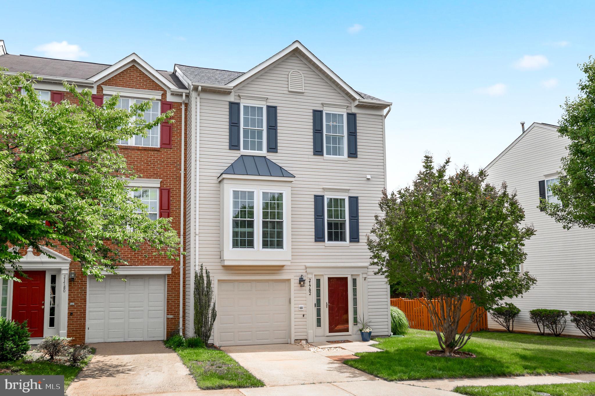 Spacious, light-filled end-unit townhome with 3 bedrooms, 2 full bathrooms, 2 half bathrooms, a 1-car garage, and a fully fenced yard. The entry level features a family room, half bathroom, laundry, garage access, and rear exit to the fenced backyard. The main level offers hardwood floors, a large living room with a half bathroom and storage closet and kitchen with granite countertops, subway tile backsplash, center island, and pantry. Off the kitchen, the family room features a gas fireplace, with the dining area nearby and sliding glass doors leading to the rear deck. Upstairs, the primary suite features a vaulted ceiling, large walk-in closet, and en suite bathroom with double vanity, soaking tub, and separate shower plus two additional bedrooms and full bathroom. Located in a quiet community with amenities including a pool, pickleball and tennis courts, playground, and sidewalks, all with convenient access to Route 28, Route 7, shopping, dining, hiking trails, and athletic fields. Updates include: roof and gutters (2025), attic insulation (2025), sliding glass door in kitchen (2023), front storm door (2023), rear door and storm door (2023) and carpet (2022).