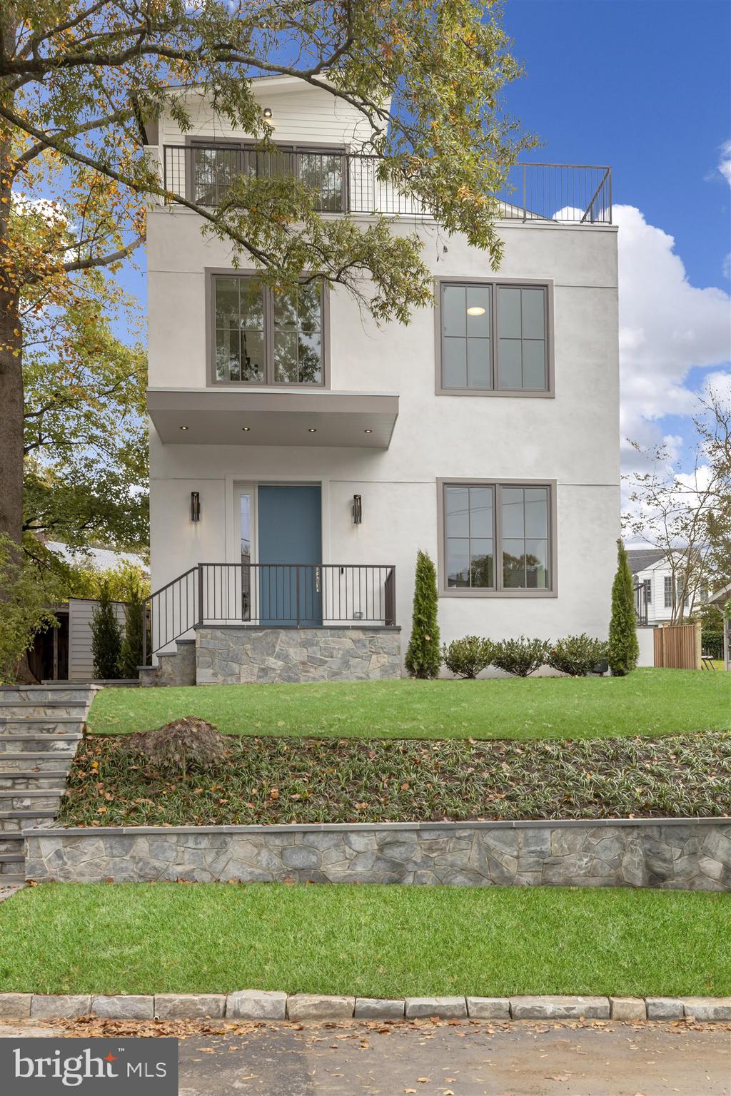 HDBUILDS presents 4929 Sherier Place NW, showcase NEW construction defined by expert craftsmanship, handpicked finishes and a premier location in the most desirable part of the Palisades.   This 5BR/4.5BA contemporary residence with  5,300 Sq. Ft. of finished living space and off-street parking for two vehicles sits above street level on a 4,970 SF lot.  High ceilings, large windows and deck-top views leave a lasting impression of light and scale.     Interior design by Martha Vicas delivers for the modern lifestyle. Understated luxury is found throughout including European French White Oak flooring, handcrafted millwork, Waterworks fixtures and designer lighting. Meticulously designed and expertly executed, the light-filled and generous floor plan is ideal for living and entertaining.     On the first floor each Principal Room flows together elegantly.  Airy and bright, the Gourmet Kitchen and separate Pantry exude practicality and luxury.   Custom cabinetry is accented with Calacatta White Marble counters, paneled appliances, and pendant lighting. The Kitchen opens to the Family Room that boasts a Gas Fireplace with a Marble mantle and a built-in TV with Sonos Soundbar.  Home is wired for whole house WiFi. Two sliding doors access and expand the entertainment area to include the Patio.    There are five Bedrooms on the two Upper Levels.  The Owner Suite includes a large finished walk-in closet, a second closet and a Juliet balcony. Each Bathroom features Waterworks fixtures and Marble tiling. The Recreation Room on the top level showcases an eye-catching vaulted ceiling and wall paper.  Complete with a wet bar and beverage refrigerator, the Recreation Room opens to the Roof Deck with a view that reaches Virginia.     This new home is situated in a prime location within the Palisades.  This final block of Sherier Place NW has no traffic, is very near parkland and is two blocks from the Palisades Recreation Center & Playground.    The new Owners will be walking distance to the commercial MacArthur Blvd corridor including BlackSalt and Lupo Verde restaurants, Black Coffee shop, CVS, the Palisades Sunday Farmers Market and the public DC Palisades Library. They will also enjoy being just steps from nature trails including Battery Kemble Trail, Capital Crescent Trail, and the C&O Canal Towpath..