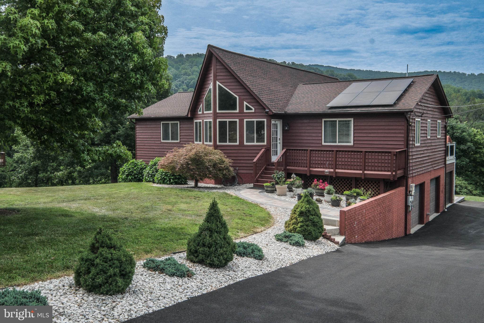 Countless 2026 updates, conveying solar panels, 2 sunrooms, 3 bay garage, private & hardscaped yard (w/views) on 1 full acre! Welcome to 17 Owens Court, a 4 bedroom, 3 bath cedar chalet tucked into a hugely private, professionally landscaped yard near the bottom of High Knob.  This window-filled home offers approximately 3,000 finished square feet, including 1,833 square feet on the main level & a fully finished lower level.  Over $188,000 in additions, improvements and market preparation since 2020—not including the new roof in 2018!<br><br>
A freshly resurfaced driveway (with impressive parking space), beautifully landscaped front & side yard & a welcoming front deck create fantastic curb appeal.  Inside, the vaulted great room features July 2026 refinished hardwood flooring, new lighting & a dramatic two-sided stone gas fireplace separating the spacious living & dining area.  The kitchen offers abundant counter space, a breakfast bar (w/ seating for 4) & waterproof LVP flooring installed in June 2026.<br><br>
The bright upper-level sunroom (accessed by french doors off the dining area) is filled with windows and features two skylights, a stone accent wall, vaulted wood ceilings & two sliding doors leading to the expansive 56 x 12 fiberglass deck.  The sunroom flooring & upper decks were upgraded with approximately $15,000 in fiberglass surfacing (offering a waterproof, weather-resistant, UV/ fade-resistant finish that is low-maintenance, anti-slip & resistant to rust, mildew, moss & insect damage).  With no exposed nails, splinters or loose boards, the fiberglass surface provides a clean, durable finish.<br><br>
The rear decks & upper sunroom were added in 2020 as part of an approximately $68,000 improvement.  Beyond the decks, the private backyard includes a substantial hardscaped patio & fire-pit area completed in 2024 at a cost of approximately $29,000, creating multiple spaces for entertaining.<br><br>
The main-level primary suite features new flooring, a ceiling fan, an updated bathroom & a walk-in closet with built-in shelving.  Two additional main level bedrooms also offer new flooring & ceiling fans.  Updated bathrooms, linen closets, hall closets, a coat closet, pantry & 2 pull-down attic accesses provide excellent storage throughout the home.<br><br>
The finished lower level features nine-foot ceilings & a spacious recreation room with a wine refrigerator, gas stove with hearth & rough-in for a wet bar with sink.  A fourth bedroom (with tile flooring, ceiling fan & closet), a full bath, wide hallway, laundry room with utility sink & a recently finished three-season room (21x12) provide tremendous flexibility for guests, hobbies, recreation or multigenerational living.<br><br>
The lower-level three-season room & third garage bay were added in 2022 as part of an approximately $17,000 improvement.  The three-bay garage includes a dedicated lawnmower door on one bay.  In July 2026, another $34,000 was invested to prepare the home for market, including resurfacing the driveway, refinishing floors, completing the lower-level sunroom & interior painting.<br><br>
Energy efficiency is another standout feature.  The owner invested approximately $37,000 in conveying  solar panels in 2022 that new owners will benefit from.  The property’s highest electric bill during the past year was approximately $41, with most monthly bills under $20. See the impressive solar documentation & utility savings information included in the documents section of the listing. Additional improvements include a roof installed in 2018 w/transferable 50-year warranty, new HVAC air handlers installed in 2025, a gas furnace, programmable thermostat & energy-smart water heater....High Knob offers a truly special community setting less than 2 miles to I-66 exit 13 (Linden), access to the Appalachian Trail, a swimming pool, community space, basketball courts, picnic area & more.  High Knob is not a traditional HOA–no sep HOA fees!