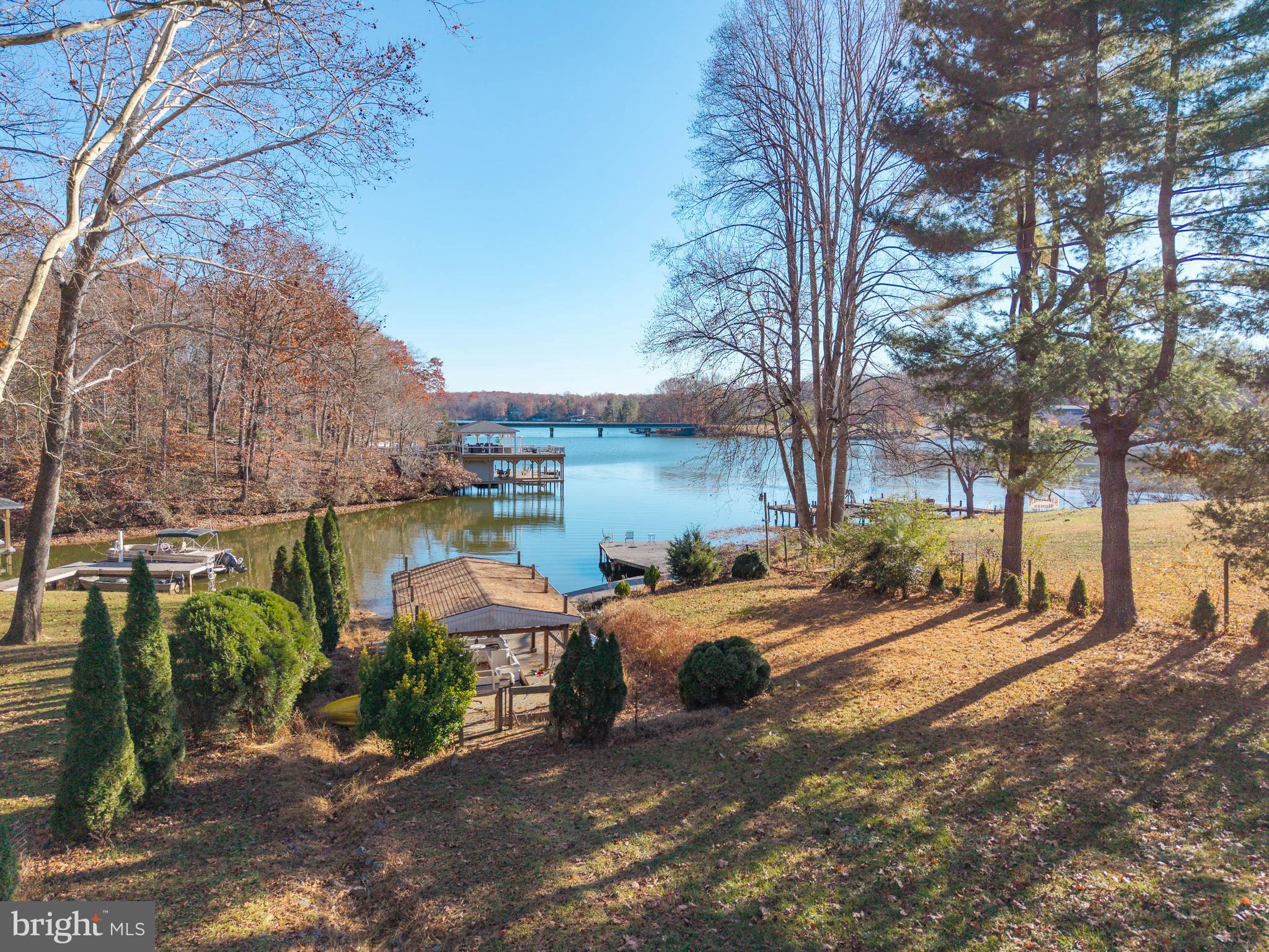 This home is ready for its next chapter—and offers the perfect canvas for buyers with vision:
Ideal for renovation, customization, or investment
Solid footprint with opportunity to modernize and add equity
Great candidate for a primary residence, second home, or short-term rental!
Escape the city and experience elevated lakefront living at Lake Anna—perfectly situated in a prime WATERFRONT location directly across from The Cove Restaurant, one of the lake’s most popular destinations.
SIGNIFICANT PRICE ADJUSTMENT means this one won't last long now! This spacious and light-filled home offers 3 bedrooms plus a versatile bonus room on the lower level and another above the ATTACHED GARAGE, along with 4 full bathrooms, making it ideally suited for hosting, entertaining, and maximizing occupancy potential. From the moment you enter, you’re greeted by sweeping lake views, soaring cathedral ceilings, and skylights that fill the home with natural light—creating a bright, open, and welcoming atmosphere guests and owners alike will appreciate.
Just off the entry, a large great room serves as a standout gathering space, complete with a full bath and direct access to the deck—perfect for seamless indoor-outdoor entertaining. Interior access to the garage and an additional bonus room above adds flexibility for expanded accommodations or private guest quarters.
The main living area features an open-concept kitchen that flows effortlessly into the dining and family rooms, along with a sunroom ideal for a home office, lounge, or additional sleeping space, and FIREPLACE. Two bedrooms on this level, along with easy access to the expansive deck, enhance functionality and guest convenience.
Upstairs, the private primary suite offers a quiet retreat with its own bath—an ideal separation of space for owners or premium guest use.
The walkout lower level is designed for recreation and relaxation, featuring a spacious living area with a WOODSTOVE, full bathroom, laundry room, and bonus room for additional sleeping or flexible use. Sliding doors lead to the patio and backyard, where the gently sloping lot guides you directly to the waterfront—creating an effortless connection to the lake.
Positioned in a highly desirable area with close proximity to waterfront dining, entertainment, and boating destinations, this home offers exceptional appeal for those seeking both lifestyle and strong rental performance. The layout, multiple living areas, and abundant sleeping flexibility make it especially well-suited for high-demand, multi-group stays.
Additional highlights include:
• NEW HVAC (2025)
• Septic recently pumped and repaired
• No HOA restrictions
• Established (long term) rental history 
Whether you're looking to expand your portfolio or secure a refined personal retreat with significant income potential, this Lake Anna property delivers on location, versatility, and long-term value.