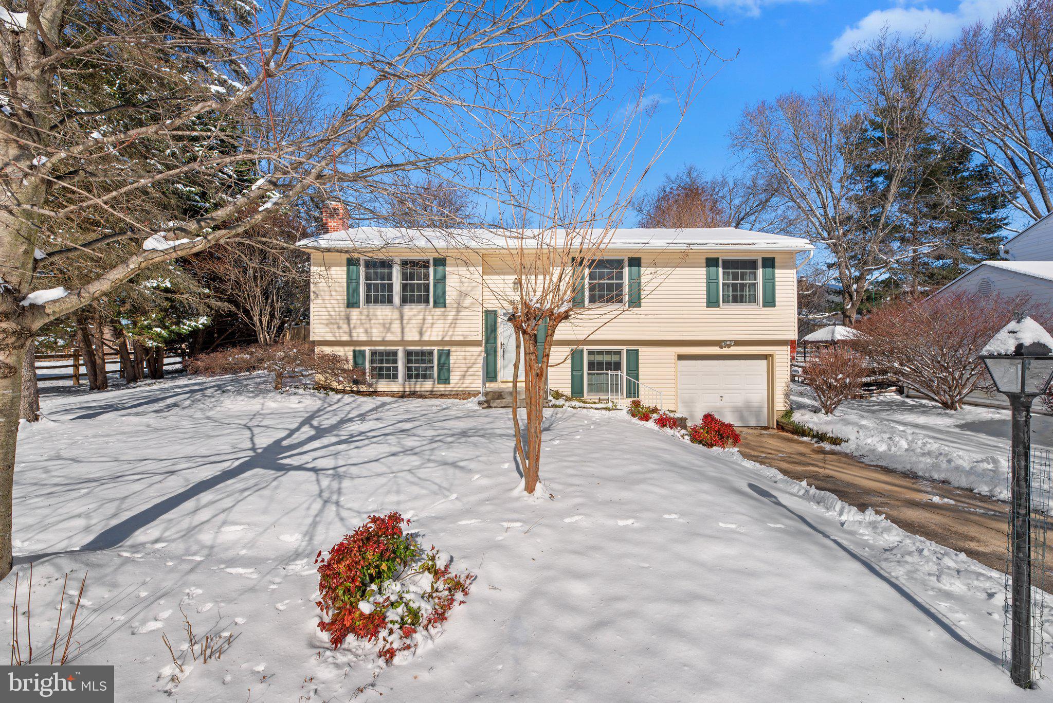 Instantly inviting, this 4 bedroom, 3 bathroom split foyer home offers 2295 square feet of casually comfortable living space. Hardwood floors flow from the vaulted living room throughout the main level. The kitchen is a hobby chef’s delight, updated with cherry cabinetry, granite countertops, tile backsplash, stainless appliances, and gas cooking. The large island and breakfast area are adjacent to the bright and airy morning room, filled with natural light from the skylights and picture windows. With its cozy gas stove and built-in shelving, the morning room and the attached, oversized screened porch are the perfect spots to look out over the picturesque rear yard. The primary bedroom features a full ensuite bathroom. Two well-sized bedrooms and another full bathroom complete the main level. Downstairs, the fully finished lower level has a large family room with a gas fireplace and plenty of room for gathering. The fourth bedroom has built-in cabinets, a large window, and is the ideal space for a home office or hobby room. The large laundry room with utility sink and storage cabinets leads to the attached 1-car garage. Outside, the expansive rear yard offers two patios, mature trees, flower beds, and landscaping, all backing to Columbia Association park space for the ultimate in peace and privacy. At the cul-de-sac’s end, a walking path leads to the nearest neighborhood tot lot. Consider a Columbia Association Play membership, which provides access to not only nearby Locust Park pool, but all of CA’s indoor and outdoor swimming pools, ice skating rink, tennis and pickleball courts, and Columbia’s own mini-golf course. Outdoor enthusiasts will love the proximity to Blandair Park, complete with picnic pavilions, several uniquely themed playgrounds, and multiple well-maintained sports fields, including soccer, baseball, and softball fields. For peaceful outdoor enjoyment, Jackson Pond is in close proximity and offers a tot lot, fishing pier, picnic area, and the walking trail loop that winds around the pond providing a serene retreat. Weekends are made for exploring the nearby shops, dining, breweries, nightlife, and recreation of Columbia's Town Center and nearby Old Ellicott City. Commuters will especially appreciate the central location and the short drive to 100, 29, 32, 95 and the Snowden River Parkway Park & Ride, making travel to DC and beyond a breeze. With its thoughtful layout, updated kitchen, cozy interior, and delightful outdoor spaces, this home is ideal for anyone looking for a peaceful retreat that remains connected to the convenient, vibrant lifestyle of the area.