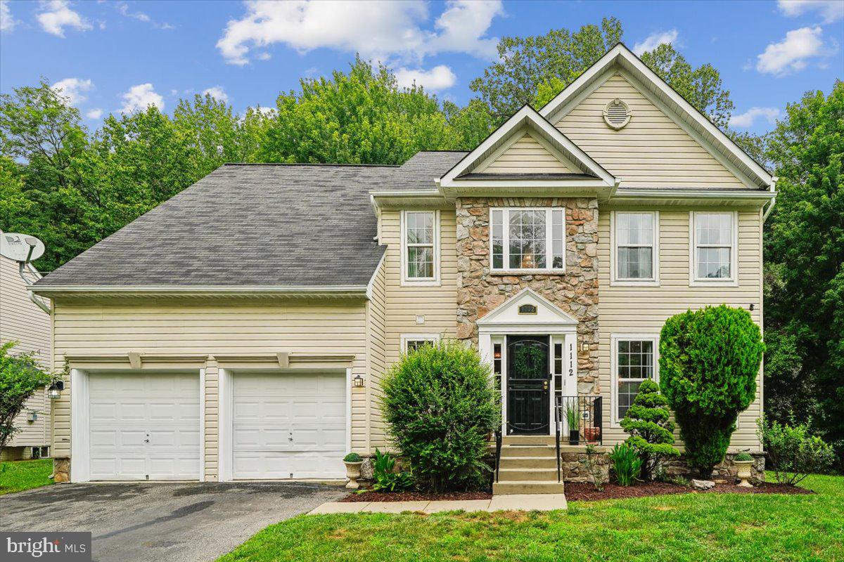 Welcome to this beautifully maintained 4-bedroom, 2 full and 2 half bath brick and stone front Colonial offering the perfect blend of space, comfort, and convenience. The inviting marble foyer welcomes you into a thoughtfully designed floor plan featuring a spacious family room with a cozy gas fireplace, seamlessly connected to the kitchen. The kitchen boasts luxury vinyl plank flooring, stainless steel appliances, a striking stone backsplash, a brand-new double oven, a new refrigerator (2026), and a brand-new dishwasher.  Step outside to the deck just off the kitchen, overlooking the generous backyard perfect for outdoor entertaining or simply relaxing. The main level also features the convenience of a laundry room with washer and dryer. Upstairs, the spacious primary suite offers two walk-in closets and a private en-suite bath. The freshly painted lower level provides exceptional flexibility with three bonus rooms and a dedicated theater room ideal for a home office, gym, hobby space, or guest accommodations. Additional updates include a newer roof and HVAC system, both replaced in 2021, offering added peace of mind. Complete with a two-car garage, no HOA,  an alarm system with cameras and centrally located for easy access to shopping, dining, commuter routes, and everyday conveniences, this move-in-ready home is perfectly timed for summer enjoyment and is ready to welcome its next owners!