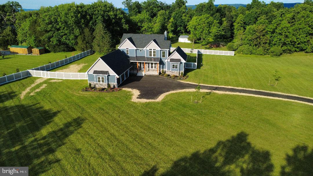OFFERING A $10,000.00 SUBSIDY TO ASSIST BUYERS WITH CLOSING COSTS.

No HOA. Set on just over 2.5 acres in Harpers Ferry, WV, this custom Craftsman-style farmhouse is minutes from Shepherdstown and Harper’s Ferry in Jefferson County. Marc commuter train is 2 miles, 4 minutes away to travel into DC. House has over 4,000 finished square feet, 5 bedrooms, and 5.5 baths. Master suite is located on main level. Upstairs has 3 bedrooms, each with their own private baths and walk in closets, and a 2nd upstairs vaulted game room.  Kitchen features quartz countertops, a 6-burner professional-grade Forno gas range with buried propane tank, a professional series side-by-side full size refrigerator/ full size freezer, and custom cabinetry with a large center island. 5th bedroom with bathroom located in the partially finished walk-up basement. Fenced in backyard is ready for a pool, 5 bed septic located out of the way in side yard. Paved street and driveway lead to 3 individual garage bays.