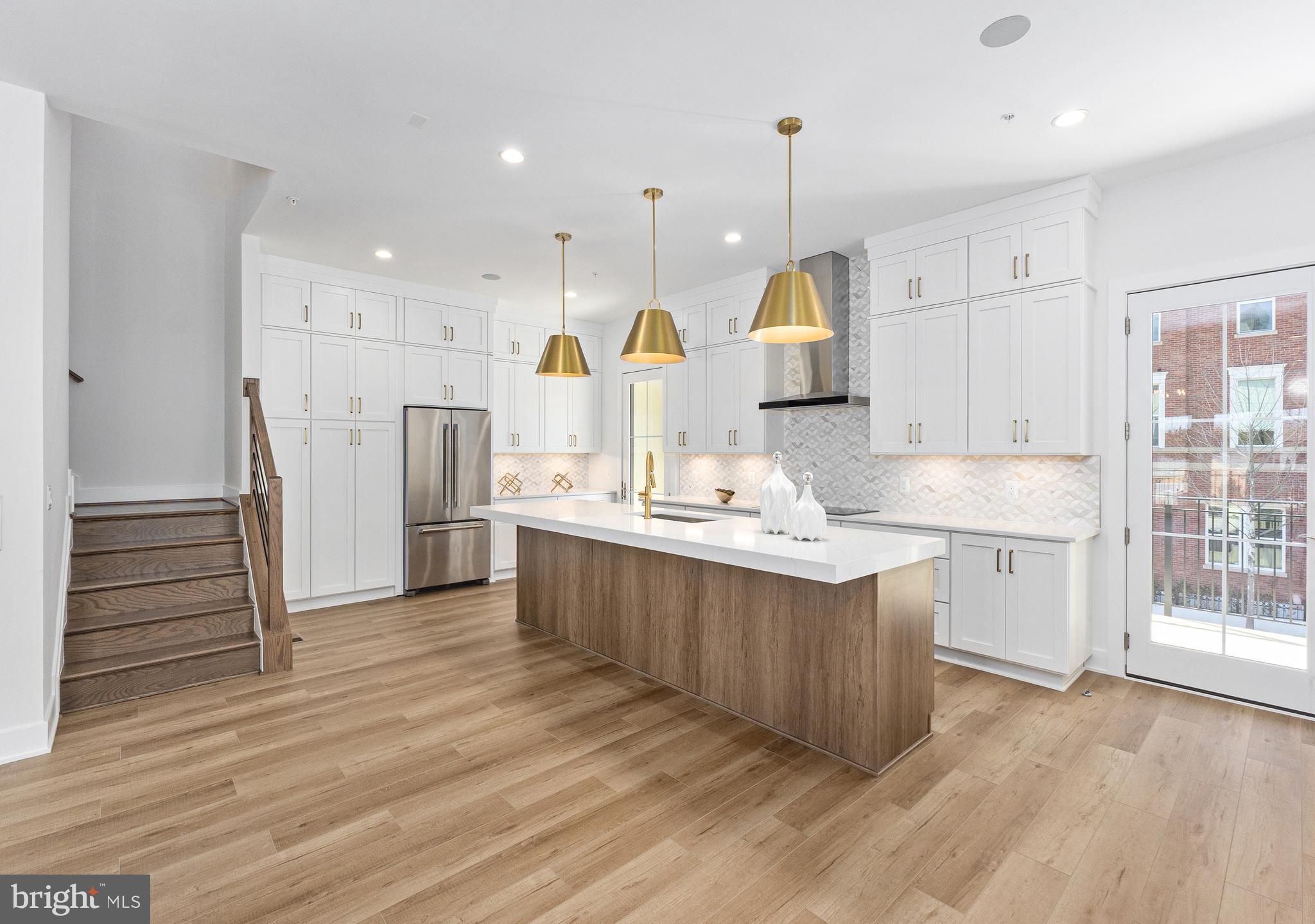 This home offers an exceptional fusion of sophistication and comfort across four expansive levels, elevating your lifestyle at every turn. The inviting foyer sets the tone for the home, leading into a versatile flex room that can be customized to suit any need. On the first floor, a bedroom with a full bath provides convenient guest accommodations. An elevator serves all levels, ensuring ease and accessibility. The second floor opens to an airy great room and a casual dining area, both bathed in natural light from a stunning balcony. The chef-inspired kitchen is equipped with stainless steel appliances and features a spacious island with a breakfast bar, abundant counter and cabinet space, and access to a charming covered deck. A well-appointed butler’s pantry off the Great Room offers an ideal space for storage and entertaining. Throughout the home, elegant oak-stained stairs have been added with sleek horizontal iron railings providing a timeless touch, adding to the home's refined aesthetic. The third floor houses the serene primary suite, complete with a generous walk-in closet and an elegant bath that boasts a dual-sink vanity, a luxe shower with a built-in seat, ample linen storage, and a private water closet. The suite is further enhanced by a soffit ceiling, adding to the sense of space and tranquility. Two secondary bedrooms, one with a walk-in closet, share a beautifully appointed full bath with a dual-sink vanity. The fourth floor features a remarkable rooftop terrace, perfect for entertaining or relaxing, with a cozy fireplace and a retractable awning to enjoy the outdoors in comfort year-round.
