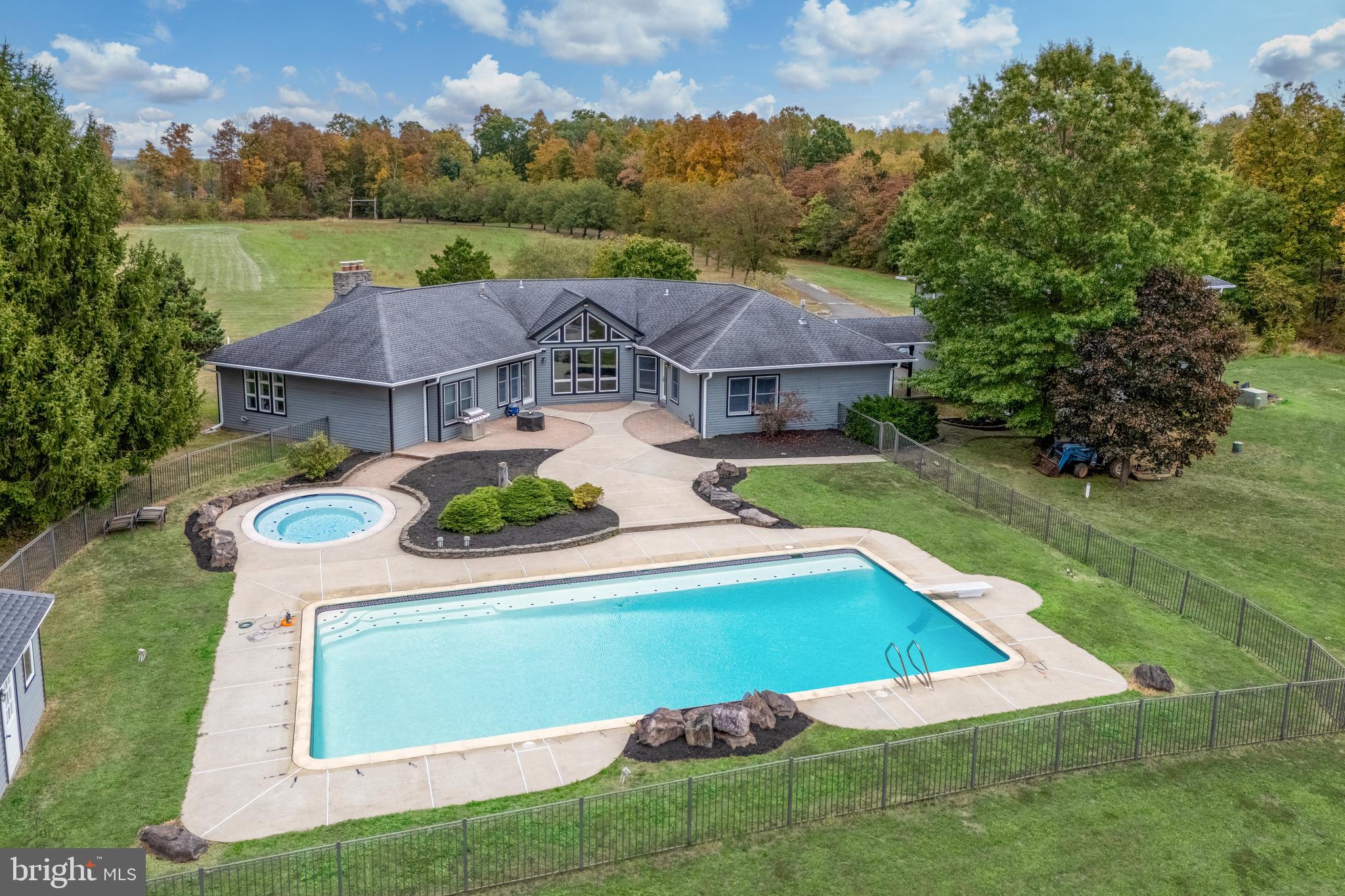 Circle T Ranch on 12.55 open & level acres offers the rare combination of upscale country living on a very private estate along with easy commutability to Philly and surrounding areas. Located minutes from the PA turnpike and other major arteries. This architecturally pleasing and spacious 4 bedroom 3 bath home enjoys convenient one floor living with an abundance of windows that capture pool and pasture views. Soaring 10 foot ceilings and open spaces flow beautifully together to create the main gathering areas. The current owners updated  the kitchen with custom oak cabinets, granite counter tops, stainless steel appliances, tile floors, granite sink and stone tile backsplashes with pewter inlays. A large pantry, 4-seat breakfast bar, built in microwave, convection oven, InSinkErator (instant hot H20 190 degrees) & warming drawer complete this space. The kitchen opens into a spacious dining room with large windows with high vaulted ceiling with exposed open beam and hardwood flooring. Rear windows in kitchen thru master bedroom are all tinted. A floor-to-ceiling stone gas fireplace flanked by large windows is the focal point of the 18 x 34' great room, further enhanced by high vaulted ceiling w/ exposed beam and hardwood flooring. Tucked away in a private corner the sumptuous master suite has a stylish vaulted ceiling, walk-in closet and romantic master bath with a Jacuzzi tub adorned with attractive tiling and windows and a spacious tiled shower. Library with built-in bookcases. A bedroom is equipped with a private bath and walk-in closet. The other bedrooms are joined with a jack-and-jill bathroom. Large tiled laundry room with sink and walk-in closet. The amount of closet space is impressive in this home. 4+ ft high ceilings in basement, concrete floor & walls w/ exterior access. A breezeway leads to an oversized 2 car garage w/ not only heat & A/C & a powder room, but above houses a 1000' recently remodeled  2nd floor in-Law Suite w/ A/C, 2 bedrooms & 1 bath. In warmer weather, luxurious outdoor living can be enjoyed on a generously sized patio which is home to an Olympic size (25 x 50) lap pool and separate heated hot-tub. Other offerings include a pool house & a  pond in rear of property. Approximately 6 of the acres are made up of 3 large pastures with central path to lead horses, a round pen, the barn has wall-to-wall 3/4" rubber mats with 2 airy stalls with dutch doors that open into a dry fine pebble stone paddock, a finished tack/feed room with shelving and built-in exhaust fan, sink and hot water.   Here is a list of improvements that have been done over the last several years: entire house exterior has been been repainted, all gutters &  downspouts (w/ leaf guard) have been replaced & have extended warranty, refaced kitchen cabinets (warranty guarantees for life of house), automatic shades installed on 3 windows in DR, top portion of deck leading to in-law suite has been replaced w/ Trex, pavers around pool have been redone & an additional pool gate has been added.  Very peaceful & private setting! Can have up to 12 horses on property  (buyer needs to verify w/ zoning officer).  Boarding facility/riding academy is possible w/ a conditional use permit from township that buyer would need to apply for.