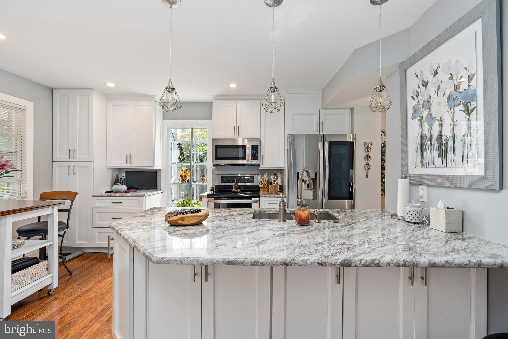 ***HIGHEST AND BEST DUE WED, 10/28 AT 12PM*** ONE OF A KIND!! Welcome To This Beautiful  End Of The Group Renovated 3 Bedrooms 2 Full Baths And 2 Half Bathroom Home. Walk In & Immediately Be Mesmerized By The Custom Work Put Into This Home. The Main Level Offers Luxury Laminate Floors Throughout The Living Room, Dining Room, & Kitchen. The Kitchen Offers Granite Countertops, Custom Cabinets, Stainless Steel Appliances, & Breakfast Bar. Living Room With Ton Of Natural Light & Coffered Ceilings. No Attention To Detail Was Missed. Walk-Up To The Upper Level, You'll Find 3 Spacious Bedrooms And 2 Full Bathrooms. The Master Bedroom Offers New Lighted His & Her Closets With Built-Ins , & Custom Tile Master Bathroom with A Rain & Wall Shower &  Double Vanity Sink . Finished Lower Level Offers A Large Family Room With Bar Area And Walk-Out To The Fenced In Back Yard.