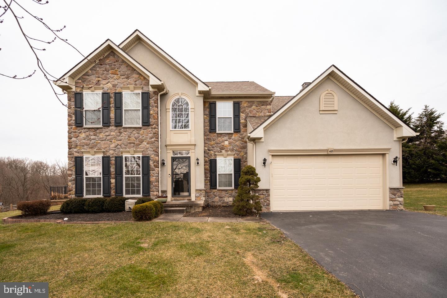 Welcome to 40 Caversham Drive, in the community of Medford Farms.  This beautiful, stone-front home has everything! Highlights include a bright open floorplan, first-floor professional office, grand primary suite, finished basement with a full bath, and an absolutely stunning outdoor space with built-in bar, hot tub, in-ground pool, and waterfall!  All of this, sitting on a peaceful .43 acres of land within the Avon Grove School District. Step inside this home to a bright, two-story foyer with a view upstairs to the second level. You will find the professional office on one side, and across the foyer is the formal dining area. Flow into the cheerful open floorplan joining the updated kitchen, gorgeous breakfast room, and cozy family room; the ideal configuration for enjoying your everyday routine with family.   This kitchen features granite countertops, stainless steel appliances, center island with seating, and additional counter seating which opens to the breakfast room with vaulted ceiling, windows on 3 sides, and a gorgeous view of your outdoor living space.  The adjoining family room has a floor-to-ceiling stone fireplace to savor during these chilly months upon us!  From the main living space, step outside to the ultimate outdoor living and entertaining space and a truly magical setting for making memories with family and friends.   Enjoy a wrap-around Trex deck with corner hot tub and built-in stone bar, a patio dining area with pergola, and a gorgeous in-ground pool with stone accents, zero entry, and waterfall.  Start getting excited about summertime!  Back inside and completing the main level is a powder room for guests and the main floor laundry room.  Upstairs, you will find all 4 bedrooms and 2 full baths, including the spacious primary suite with double-door entry and gorgeous updated primary bath with double vanity, corner tub, glass shower, and linen closet.  The finished lower level of this home offers endless possibilities with recessed lighting and several useful spaces to accommodate your needs, including a full bathroom.  Use this area as a rec room, game room, movie room, additional office, in-law suite, a 5th bedroom, or whatever your needs require.  Bonus features and upgrades of this home include a new water heater (2021), a new roof (2020), and an additional 2nd floor AC unit.  Located in the heart of West Grove, close to schools, shops, restaurants, parks, Inniscrone Golf Course, and within the top-rated Avon Grove School District.  Be sure to view the virtual tour and schedule a showing today!