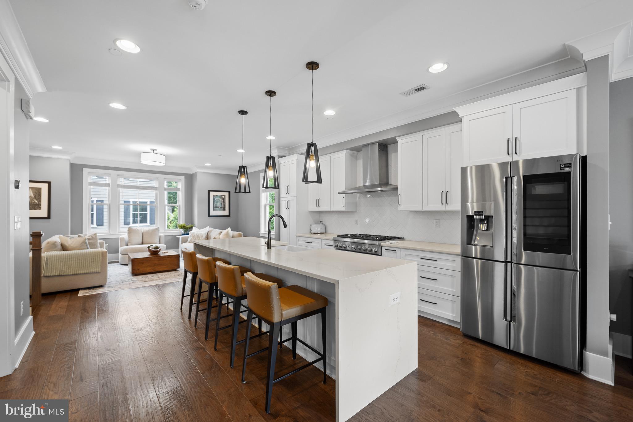 Welcome to this stunning 2018-Rockwell built townhouse located within walking distance of the vibrant town of Ardmore! This contemporary home features 4 spacious bedrooms, 4.5 luxurious baths, and an attached 2-car garage equipped with an EV charger. 
Step inside to discover an open-concept floor plan that seamlessly connects the dining area, gourmet kitchen, and inviting living room. The white and bright kitchen has stainless-steel appliances, a generous island with seating for four, and ample room for both cooking and entertaining. The living room offers custom built-ins, providing both style and functionality, creating a perfect space for relaxation and entertainment. Step outside onto the deck to enjoy your morning coffee or grill your favorite meal.  
Upstairs, the generous main bedroom is a serene retreat featuring a seating area, a large professionally organized walk-in closet and an ensuite bathroom that exudes luxury with double sinks, a private WC, and an oversized tiled shower.  An additional bedroom with a spacious walk-in closet and a full bath that includes a tub/shower.  The laundry room completes this level.  
On the top floor, is a large third bedroom featuring an ensuite bathroom and a spacious closet.  This room is currently used as an office. Additional attic storage is available too.  
The ground floor has an attached two-car garage, a mudroom area, and the 4th Bedroom. This over-sized room includes a beautiful en suite bath. Currently this room is being used as a Den and provides lots of options for use. High-end finishes throughout the home elevate the living experience, from the elegant wood flooring to the sophisticated fixtures and crown molding. This townhouse offers both luxury and practicality, making it the perfect place to call home. Don't miss the opportunity to own this exquisite property in one of the most desirable locations and in one of the top school districts, Lower Merion.  Ardmore is a thriving community filled with an array of restaurants, shopping, and entertainment options, including Suburban Square, and offers convenient access to the R5 train and Amtrak, making commuting a breeze. Come see the best of suburban living with urban conveniences!
