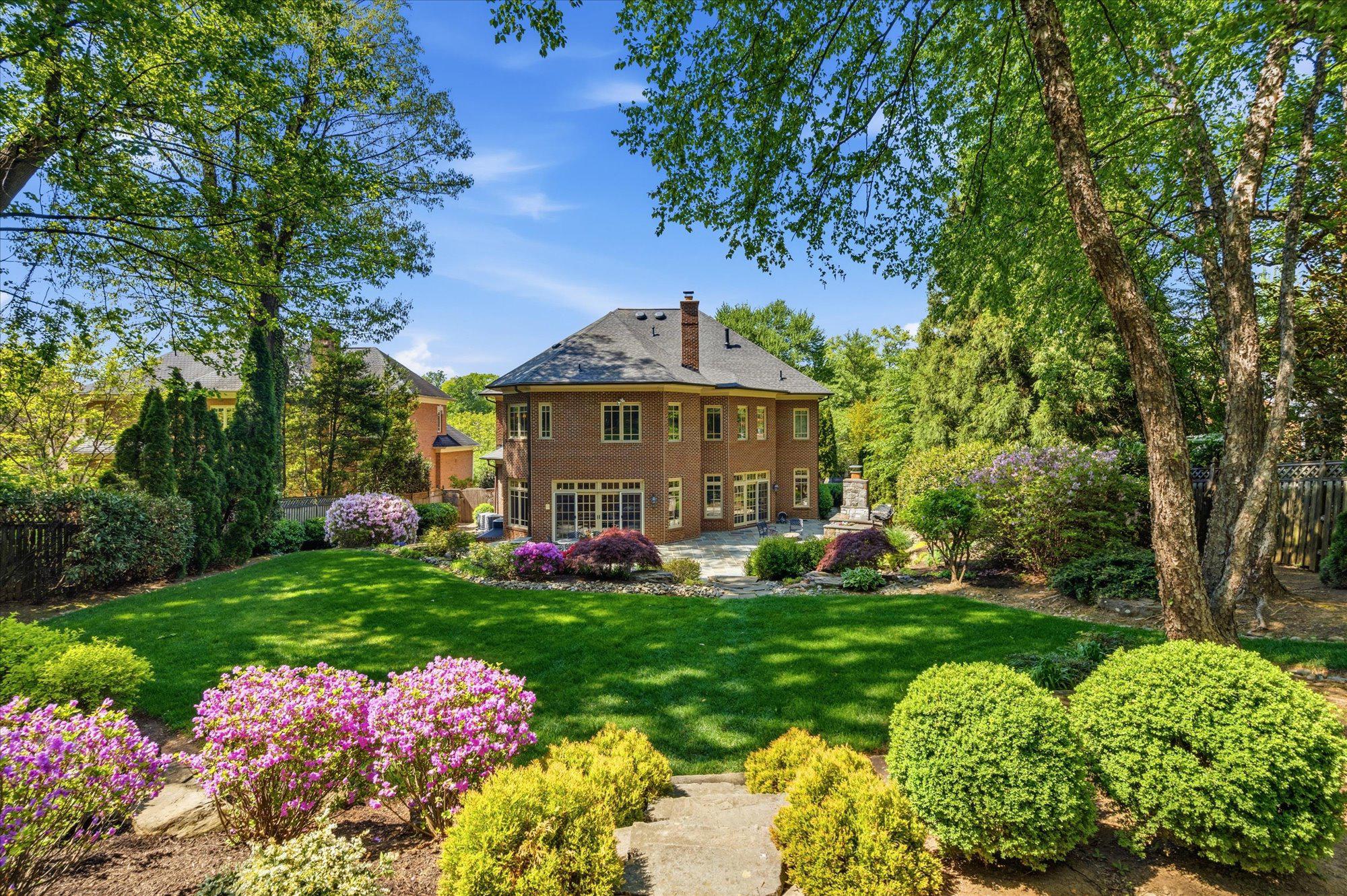 Welcome to 6704 Honesty Drive, an exceptional custom luxury home in Bethesda set on more than half an acre of beautifully landscaped, park-like grounds in one of the area's most coveted neighborhoods. Offering over 7,600 square feet of thoughtfully designed living space, this timeless residence combines classic architecture, premium craftsmanship, and extensive recent updates to create an extraordinary place to call home.

Designed for both elegant entertaining and comfortable everyday living, the heart of the home is a spectacular chef's kitchen featuring new Wolf and Sub-Zero appliances (2024–2025), upgraded custom cabinetry, an oversized center island, and generous prep and gathering space. The kitchen flows seamlessly into the sun-filled breakfast room and dramatic glass-wrapped sunroom, where walls of windows overlook the private backyard.

Outdoor living is equally impressive. A refinished bluestone patio with a wood-burning fireplace, dedicated gas line for grilling, irrigation system, natural boulder accents, and professionally designed landscaping create a resort-like setting perfect for entertaining or quiet evenings at home.

The luxurious primary suite offers a true retreat with dual custom California Closets walk-in wardrobes and a spa-inspired bath featuring a steam shower, soaking tub, and new Phylrich fixtures (2024). Three additional spacious bedrooms each enjoy beautifully updated ensuite baths.

Exceptional living spaces include gracious formal living and dining rooms, a welcoming hearth room with a gas fireplace, rich hardwood floors, abundant natural light, and dual staircases that provide effortless flow throughout the home.

The finished lower level expands the home's versatility with a spacious recreation room featuring custom Rutt cabinetry, a dedicated home theater wired for projection and surround sound, a private fitness room, and a separate guest or au pair suite with an upgraded ensuite bath.

Recent improvements provide peace of mind and modern efficiency, including three new Carrier furnaces (2024), a CertainTeed Landmark roof with copper gutters (2023), a 75-gallon Bradford White water heater, Speed Queen laundry (2025), and fresh Benjamin Moore Aura interior and exterior paint.

Located within the highly sought-after Whitman, Pyle, and Burning Tree school cluster and just minutes from downtown Bethesda, premier private schools, shopping, dining, and the Potomac River trail system, 6704 Honesty Drive offers an exceptional combination of luxury, privacy, convenience, and enduring value.