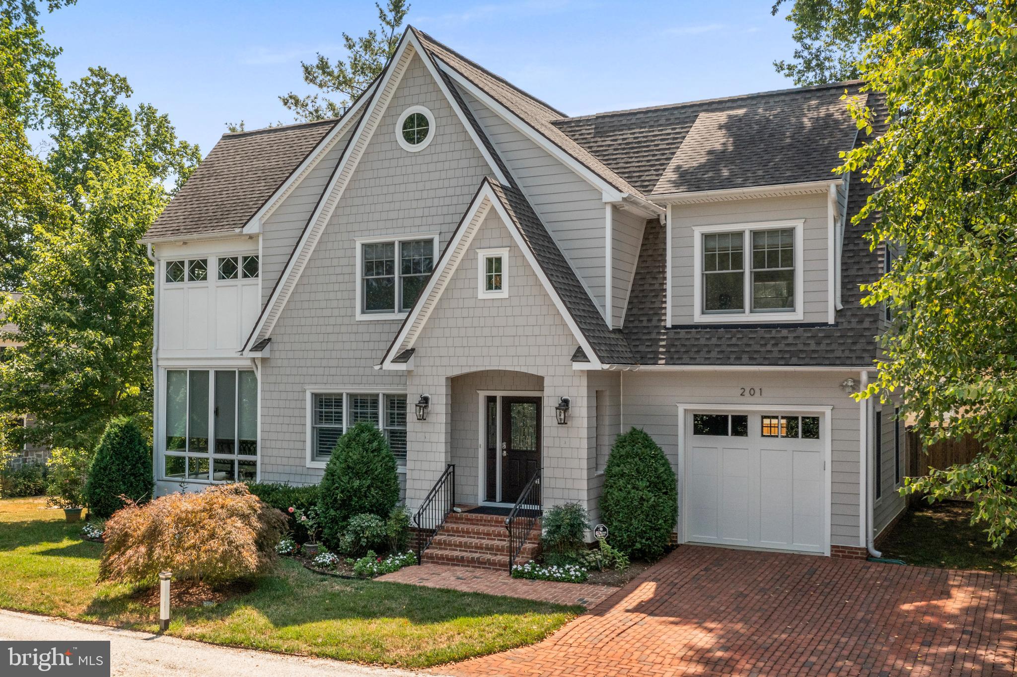Located in a park like setting  of Eastport  adjacent to The Point and a block from the water, this eight year old 3500+/- sq foot beautifully designed Cape Cod  includes an elevator providing effortless access throughout.    The home boasts a comfortable open floor plan  and numerous custom upgrades.  Detailed woodwork includes coffered ceilings, built-in cabinetry and bookcases, hardwood floors, detailed millwork, 2 gas fireplaces with custom mantles, recessed lighting, custom wood plantation shutters and ceiling fans. The main level  with 9 foot ceilings, features a true cooks  gourmet kitchen with cherry and maple cabinetry, granite island and counters, Kitchen Aid appliances and is centered between the dining area and living room. A stand-out feature is the sunroom, which transitions easily from a sunroom to a screened porch with its custom enclosure and year-round comfort ensured by its own cooling and heating system.  Anderson sliders lead to trex deck with railings overlooking the professinally landscaped yard with landscape lighting. 
Upstairs, four bedrooms include a primary bedroom with soaring ceilings that extend into the luxurious spa-like bathroom as well as a spacious laundry room. The lower level, also with 9 ft ceilings,  offers a family room with a bar, gas fireplace, and a recreational area with a full bath, complemented by sliding glass doors leading to a covered patio and lush yard. You will also find a  rare one car garage,  driveway parking for two cars and plenty of overflow parking just 60 steps away adjacent to  the President Point tennis courts.  This property is in mint condition and has been meticuously maintained. Move right in and enjoy this as your permanent home or a weekend "lock and leave" getaway. Enjoy leisurely walks along Eastport's maritime streets as you access the acclaimed restaurants, pubs, and waterfront parks.  Downtown Annapolis and the Naval Academy are just steps away. Annapolis blends small-town charm with cosmopolitan amenities, and its proximity to major routes like Rt. 50 and 97 provides quick connections to Baltimore, BWI, Fort Meade/NSA, and Washington, DC.