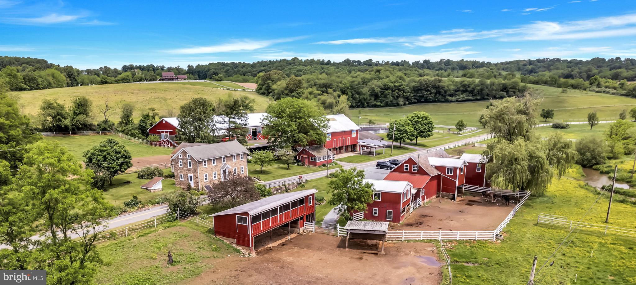 Schocharie Ridge Farm, established in 1984, is a beloved fixture in the local equestrian community. Its owner of 39 years has poured her heart & soul into making this epic 48 preserved acre farm into a vibrant facility. A strong boarding history has kept this business in the $. The large indoor & lighted outdoor rings, 30 acres of spacious pastures w/ a mix of trails are currently enjoyed by 30 boarders.  6” wide vinyl electrified fencing surrounds some paddocks, tape fencing in other turnout areas, coated high tensile fencing in back pastures. 19 box stalls, 3 run-in sheds, a tack building, washing areas, milk house & other buildings (2 of which could possibly be made into an apartment) make up the rest of complex. Clinics & schooling shows have been hosted here. Perfect watering set-up w/ auto-waterers & creek access. No hoses or carrying buckets! Boarding rates are below market & can be improved. Super low taxes!  A charming 4 bedroom, 2 full bath stone farmhouse serves as the residence. Large eat-in custom kitchen w/ brand new granite counter tops, new cook-top & new stainless-steel sink, oak cabinets & tile floors. Formal dining room has oak floors & built-in authentic concrete safe. Random-width newly refinished floors in living room w/ wood stove & stone hearth. Nice office. Large mudroom was just renovated. Most rooms & some woodwork recently repainted. Floors have either been refinished or new flooring installed. Much of the electric has just been updated & a new oil tank installed. There is a 2-acre lot w/ views included that is un-preserved & could be built upon or sold off separately by new owner with a minor subdivision approval.  A 9 acre field produces hay.