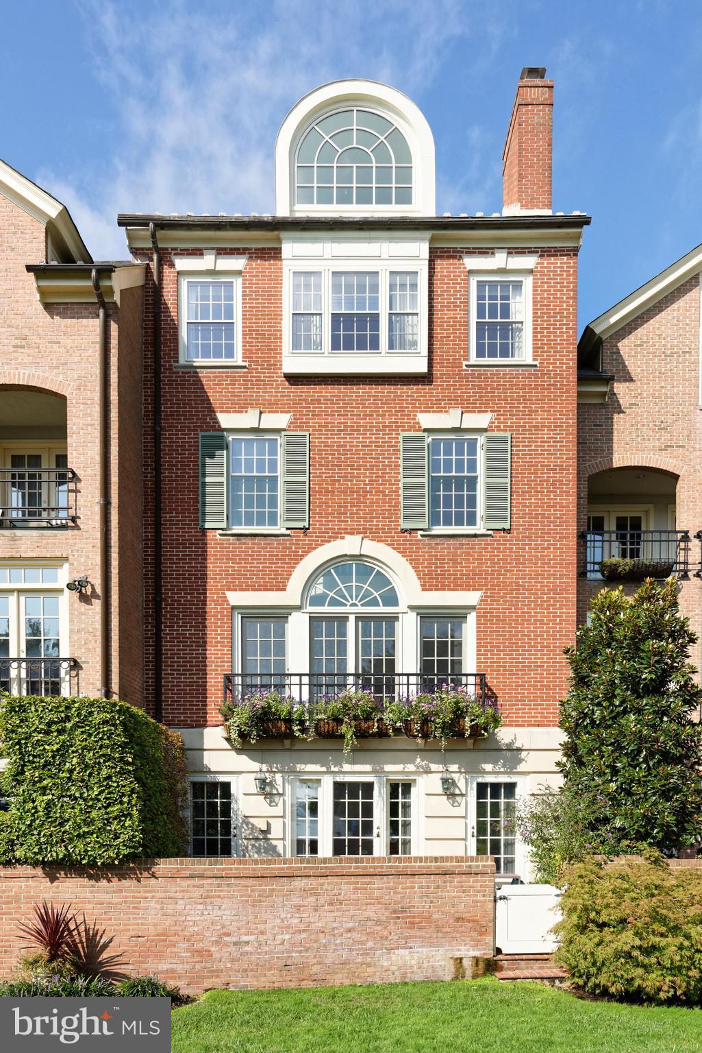 Idyllically located on the Potomac River, this stunning 5-story townhouse in desirable Old Town is a rare offering and charming jewel. Experience incomparable waterfront living with elegant interiors, plus the coveted conveniences of your own private boat slip and attached 2-car garage parking! An interior wood-clad elevator as well as a staircase transport you to all 5 stories of this special residence featuring 3 bedrooms, 4 full baths and 3 half baths with lovely grass cloth wall covering. Generously-sized rooms are enriched by gleaming hardwood floors, 4 gas fireplaces, tasteful moldings, exquisite millwork, and refined finishes throughout creating an ambience melding classic character with modern design.  Upon touring this one-of-a-kind property you'll be awed by the prime riverfront address and breathtaking water views enjoyed from both in and outdoors. A marble entryway greets your arrival on the first level, leading to a step-down family room and powder room. Relax in the comfortable family room graced by tall dentil moldings, a marble-hearth fireplace flanked by built-in bookcases, and triple sets of doors opening to the blissful brick patio overlooking the river.  On the second story, a paneled archway spills into the dramatic airy living room, a perfect backdrop for entertaining. Ceilings soar to 18 feet, and the tall Palladian window and glass doors provide an extraordinary view of the water and Maryland shoreline! Share meals together in the formal dining room accessed by pocket doors from the butler's pantry and the brand new chef's kitchen with sleek marble countertops and backsplash, and premium appliances including a Sub-Zero fridge. A powder room sits nearby for guests.  Level 3 offers utmost serenity with a handsome library facing the river, adorned with floor-to-ceiling built-ins and an overlook to the living room below. There's also a guest suite with walk-in closet, linen closet, full bath, plantation shutters, and hallway powder room.    The fourth floor is reserved for the wonderful master suite. Double pocket doors open to your peaceful bedroom retreat enhanced by picturesque water views. His and hers bathrooms each come equipped with their own walk-in closets, with a seamless shower in his and a Jacuzzi tub and additional built-in wardrobe storage in hers.  A skylight stairwell and new large arched picture window with water views welcome you to the 4th story.  Here you'll find a divine guest bedroom suite with full bath and storage galore including a large closet with 2 sets of double doors, extra storage in the eaves, a big cedar closet, plus laundry room with cabinetry and sink.  Among the other attractive highlights of this gem are a sound system, tankless water heater, central vacuum, and intercom.  Perhaps best of all is the locale, affording you an unparalleled opportunity to sit and read by the water, or take your boat out for a day of fun, all mere steps from the Potomac River and beautiful green spaces.