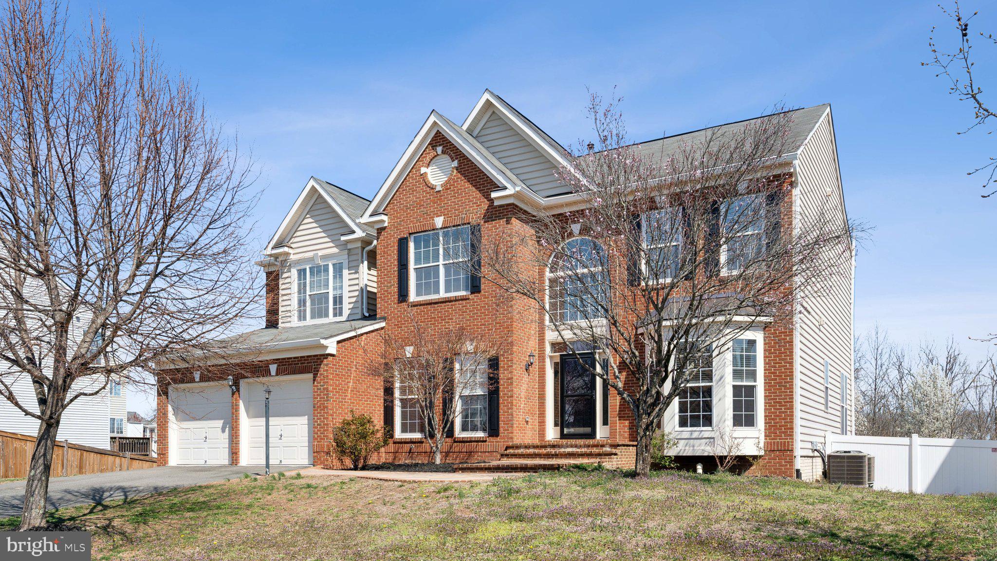 Welcome to this breathtaking 6-bedroom, 4.5-bathroom brick Colonial, perfectly situated on a premium lot backing to serene common areas and a scenic community walking path. From the moment you arrive, the custom stone and brick walkway leads you to an impressive two-story foyer, setting the tone for the elegance within.

Thoughtfully designed for both comfort and sophistication, this home boasts beautiful moldings, recessed lighting and hardwoods throughout the main level,  formal living and dining rooms, a private home office, and a grand great room featuring a floor-to-ceiling stone hearth and striking coffered ceilings—a space that invites both relaxation and refined entertaining.

The gourmet kitchen is a chef’s dream, complete with a large center island, gleaming granite countertops, an abundance of cabinetry for ample storage space,  stainless steel appliances, a corner sink with views to the backyard and a terrific built-in desk. The convenient main-level laundry/mudroom adds everyday ease.

Step outside the breakfast area to your private outdoor retreat—a covered porch and deck with stairs leading down to a beautifully designed patio and fully fenced backyard -  ideal for enjoying quiet mornings or hosting memorable gatherings.

Upstairs, the luxurious primary suite offers a true private oasis with a spacious sitting area, 2 walk-in closets, and a spa-inspired ensuite bath, complete with dual vanities, a soaking tub, and a separate shower—a perfect escape at the end of the day.

The fully finished walk-out lower level extends your living space, featuring a sixth bedroom, full bath, expansive recreation room, work-out room, plus additional storage.

With over 5,000 square feet, this home has room for all your needs! Don’t miss the chance to experience luxury living at its finest—schedule your private tour today!