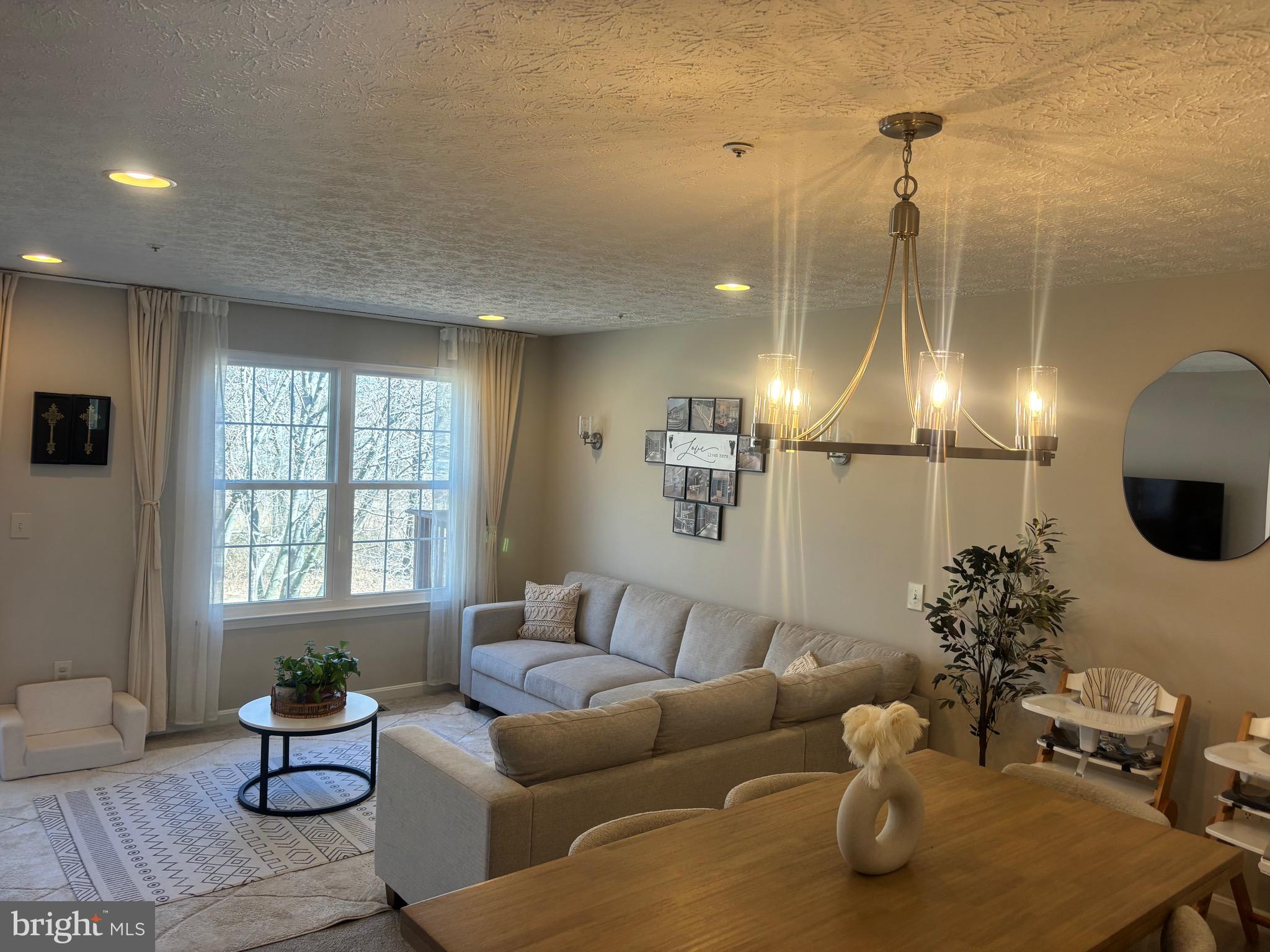 Welcome to 7158 Nature Way Rd, a stunning residence nestled in the vibrant and welcoming community of Snowden Ridge in Columbia, Maryland. This brick-front townhome is not just a place to live, but a gateway to a lifestyle filled with serenity and community spirit. Imagine waking up each morning to the gentle rustling of leaves and the inviting allure of a community trail just steps from your door. This trail, a beloved feature of Snowden Ridge, offers residents a perfect venue for leisurely strolls, energizing jogs, or serene moments of reflection amidst nature. It's a place where families bond, friendships blossom, and a sense of community thrives.

This home has been meticulously upgraded to offer both style and functionality. With a well maintained home noting clean walls, carpet, impressive lighting, a stainless steel fridge, and bath vanities, this property sparkles with modern elegance. The open floor plan is bathed in natural light, thanks to strategically placed windows and skylights, creating warm and inviting spaces throughout.  Step into the eat-in kitchen, where white cabinetry and modern black accents create a contemporary feel. A bay window provides a cozy nook for morning coffee/tea, while the pass-through window connects you to the dining room, adorned with a dramatic chandelier. The living room, framed by lush green views offers a perfect retreat for relaxation.

The lower level is a versatile space with full daylight windows and a walk-out slider, ready to transform into a playroom, media center, or any other flex space you might envision. Practicality meets style with a separate laundry area, storage space, and bath rough-in. Ascend to the upper level, where three finished bedrooms offer a peaceful retreat, each bathed in natural light. The primary suite features two double closets and an upgraded full bath, while the secondary bedrooms share a well-appointed hall bath.

A unique highlight of this home is the newly installed Electric Vehicle charging station, catering to eco-conscious residents and ensuring your home is future-ready.

Snowden Ridge isn't just about the home; it's about the community. Enjoy access to top-rated schools, parks, tot lots, playgrounds, and sports centers. Memberships are available at the vibrant Columbia Association, and entertainment options abound at the nearby Merriweather Post Pavilion and Amphitheater.  Come and experience a beautifully upgraded townhome where amenities and community converge, creating the perfect place to call home. 7158 Nature Way Rd is not just a residence—it's a lifestyle.