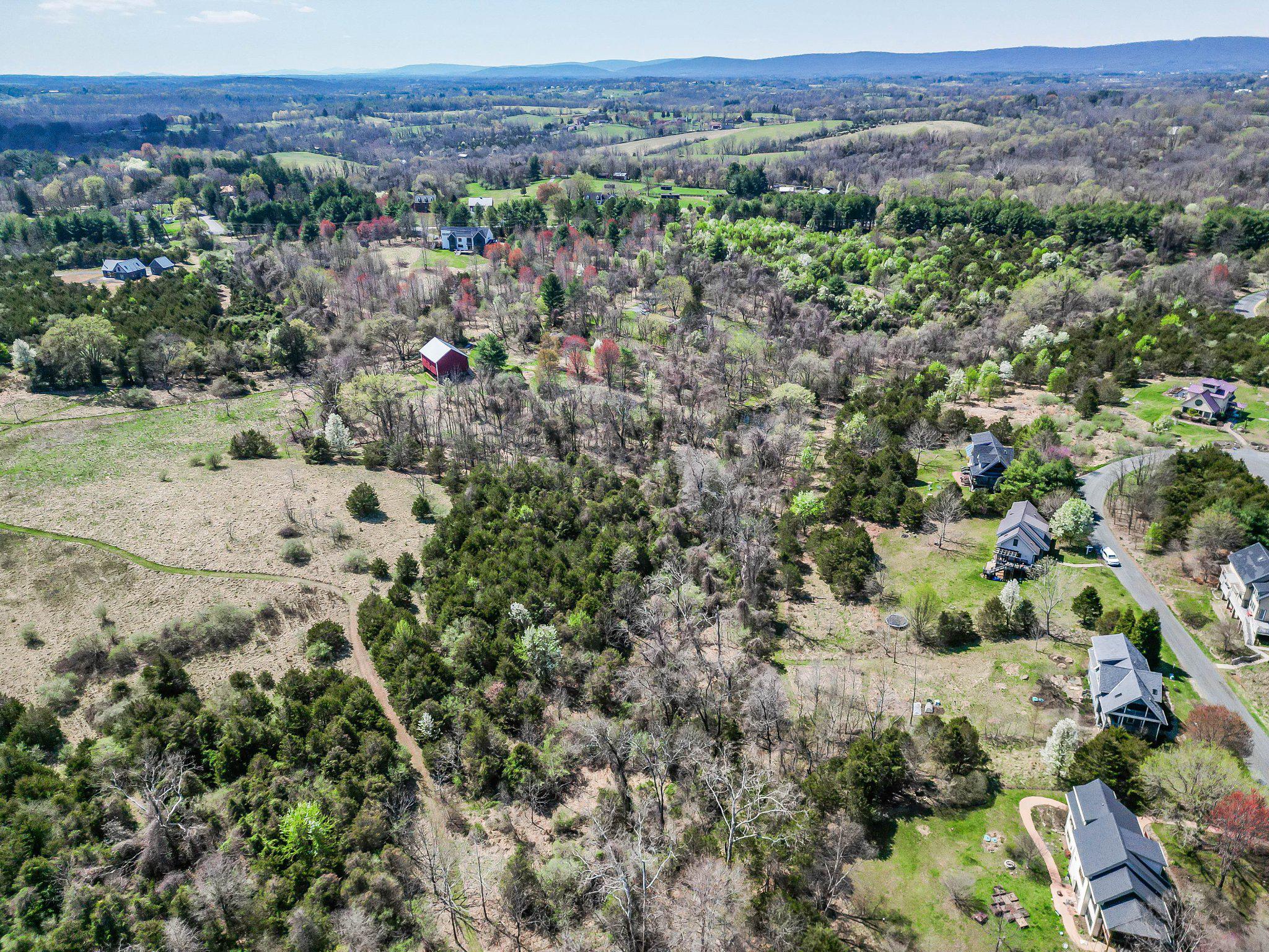 Great buildable lot in beautiful Loudoun County, between Waterford and Lovettsville, minutes from Route 15. The lot is .37 acres and is ready for you to build your custom home on. At the end of a cul-de-sac this lot has privacy and is set in the heart of a nature focused community. Well permits are in place.  Soils work was submitted and approved by Loudoun County Health Department for a 4-bedroom home, with a Certification Letter that does not expire. Per the HOA, the septic is to be analternative system. One of the great features about this property is it has access to walking trails through 90+ acres of beautiful countryside. Enjoy the natural springs and streams that run throughout the common area land. The land parcel is managed organically and maintained with no harmful substances like synthetic fertilizers, herbicides, and pesticides, making the soil ideal for growing your organic garden. Enjoy the mountain views, peace and serenity of this lot. The development phase for EcoVillage has closed, so there are no more original lots to purchase, making this a unique opportunity to purchase a lot in this great community!