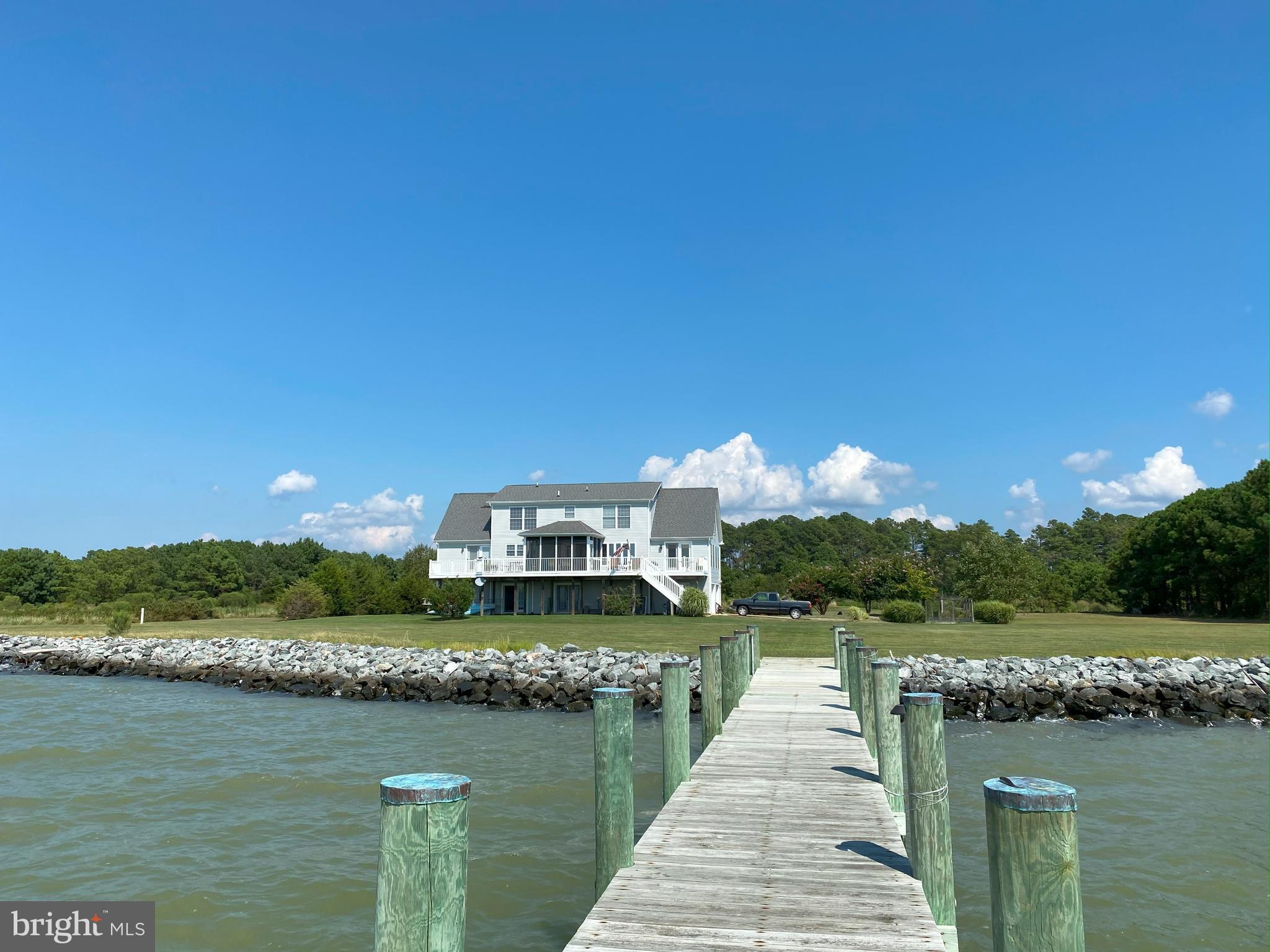 Stunning Waterfront Retreat on the Chesapeake Bay!
Experience the ultimate in waterfront living with this breathtaking home featuring 500 feet of protected shoreline on over 8 acres of serene countryside. Just 14 miles from historic downtown Cambridge, this property offers unparalleled privacy and an abundance of nature and wildlife.
Enjoy panoramic water views from every room in this 3-level home. The main level boasts a spacious kitchen with maple cabinets, a center island, and stainless steel appliances, along with a large dining area, living room, owner's suite, and a versatile dining room/office.
Upstairs, you'll find four additional bedrooms and two full baths. Entertain with ease in the 25x26 recreation room, complete with a summer kitchen and full bath, or relax on the large waterside deck, screened-in porch, and covered patio below.
The property includes a 100ft pier with a 10,000lb boat lift, perfect for boating enthusiasts. An oversized 2-car garage, dual-zone Trane HVAC units, and an additional exterior electrical panel ensure convenience and comfort. This quality-constructed home is a nature lover's paradise and a rare find!
If you're not familiar with Cambridge you might want to learn more about the new waterfront development project with plans for a promenade, hotel, restaurants and more!
