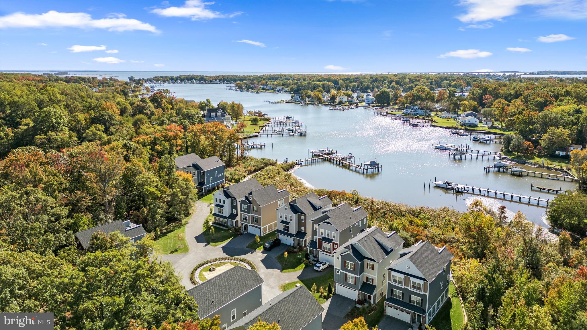 The waterfront lifestyle is ready for you! Your dream home awaits in the gated 11-home waterfront community of Waters Edge at Seneca Creek! Originally built in 2020 by Caruso Homes, this exquisite DETACHED home is one property back from the waterfront and offers both water and woodsy views. Additionally, there is a $1,000/year boat slip with boat lift available if desired. The main level offers is open concept with LVP flooring throughout, an oversized kitchen island, 2 dining areas, electric fireplace, powder room, and a home office (or 4th bedroom). Kitchen amenities include upgraded counters, backsplash, gas stove & large pantry. Roomy composite deck in the rear of the home with serene woodsy views. Fantastic primary suite also in the rear of the home with a walk-in closet, sitting area, dual sinks, and roomy walk-in shower, all with tasteful finishes. 2 additional and spacious rooms in the front of the home, plus a hall bathroom with dual sinks and a tub. Easy access to laundry room on bedroom level. Garage of your dreams, spanning the majority of the home's footprint... large enough to fit 3 cars AND have a workshop, store water equipment, etc. Carefree living with condo association covering lawn care and maintenance of the community's private dock and beach area.
