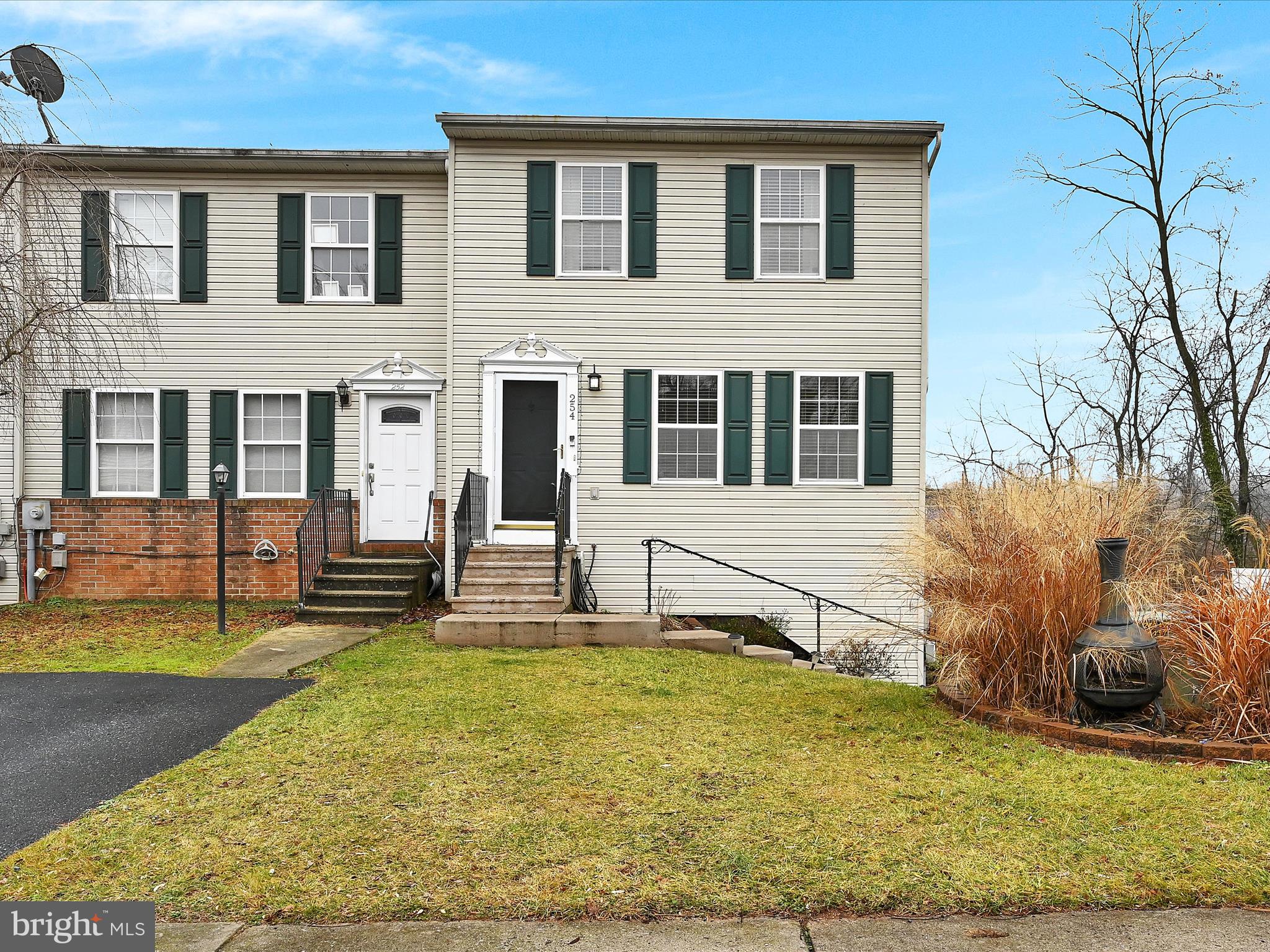 Townhome located in a  serene and private back yard setting.  An upper deck off of the main living level  & a lower deck off of the finished basement family room overlook a stream. This end unit features a side loading garage with plenty of off-street parking and a shed.  2 spacious bedrooms each have 2 closets w/ ample storage space. Light & bright kitchen adjoins dining area which is open to the living room.