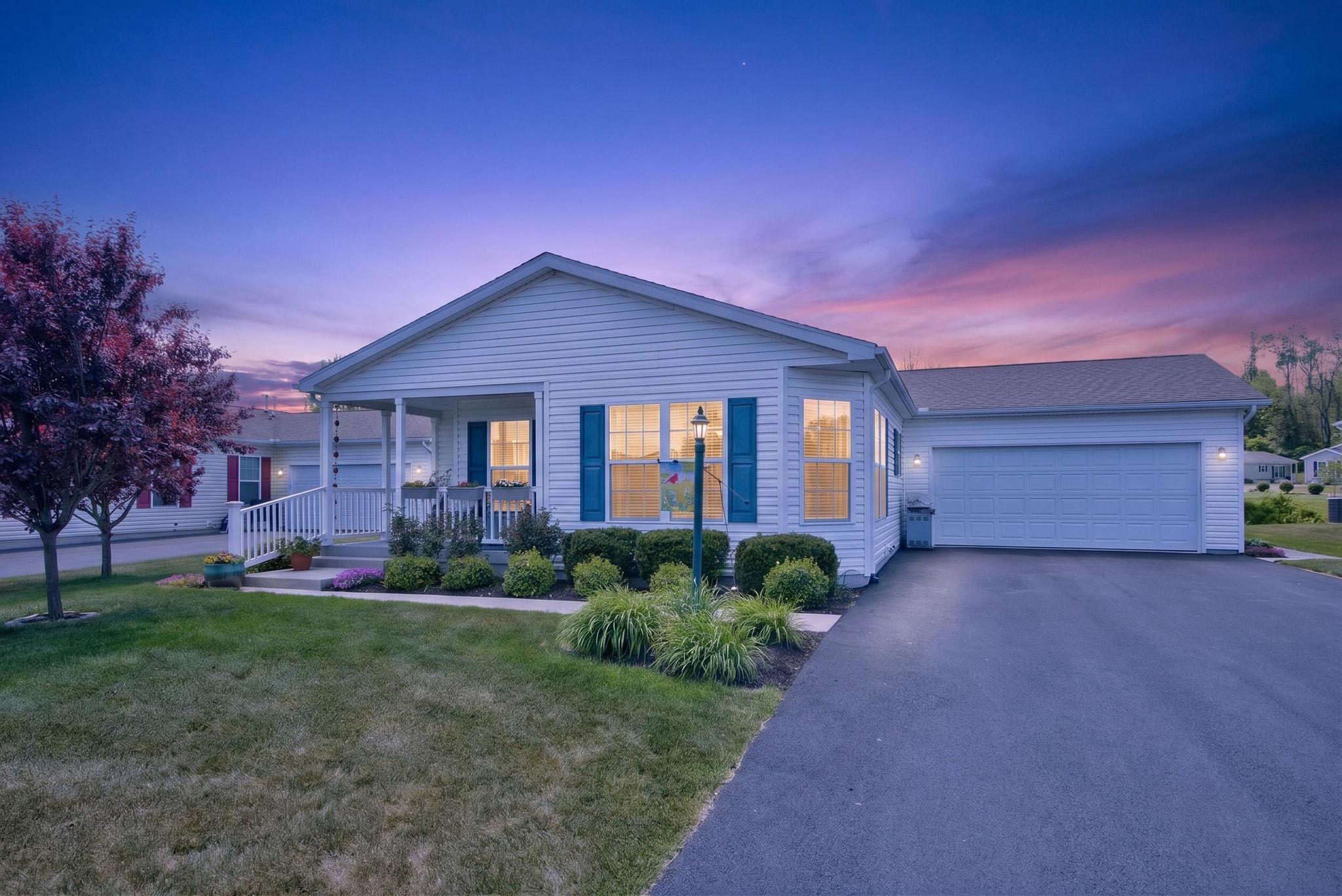 Located in the beautiful 55+ community of Spring Valley Village, 22 Waxwing is filled with thoughtful upgrades and charming details throughout. Lush, mature landscaping welcomes you to the inviting front porch, setting the tone for the warmth and comfort found inside this one-of-a-kind home. Step into the bright and airy open-concept living space where the living room, kitchen, and dining area flow seamlessly together. The dining area is surrounded by stunning windows that flood the space with natural light, creating the perfect spot to enjoy morning coffee or entertain guests. The custom kitchen is truly the heart of the home, featuring an oversized island with additional cabinetry, pull-out drawers, extra outlets, and seating. Beautiful Cambria quartz countertops pair perfectly with the custom backsplash, while matching white appliances, adjustable under-cabinet lighting, and pull-out pantry shelves add both style and functionality. The spacious living room offers the ideal balance of openness and coziness, perfect for hosting family and friends or enjoying a quiet evening at home. An added flex room provides endless possibilities for a home office, art studio, fitness area, hobby room, or den. Added soundproofing between the flex room and second bedroom offers extra privacy and versatility. The generously sized second bedroom features abundant natural light and a roomy closet. A full hall bathroom includes a granite vanity top and tub/shower combination. The primary suite offers a peaceful retreat with a walk-in closet, attached bath, and an added emergency exit door for peace of mind. The spacious primary bathroom features granite double sinks, a large soaking tub, and a walk-in shower. The hallway laundry area leads directly to the two-car garage with additional overhead storage shelving and access to the lovely three-seasons room. This relaxing space features oversized vinyl windows with easy lift-and-lock functionality, allowing you to enjoy gentle afternoon breezes and beautiful views of the wildflower garden. Watch birds gather at the birdhouse while soaking in the peaceful sounds of nature and warm sunshine. Additional upgrades include a programmable Nest thermostat, whole-house surge protector, extra outdoor electrical outlets, water softener, front step handrail, and a raised/elevated toilet for added comfort and convenience. With its beautiful setting, thoughtful upgrades, flexible living spaces, and tranquil outdoor views, this exceptional home offers the perfect blend of comfort and easy living. To make your transition even easier, the home comes with a one-year home warranty covering the remainder of this year.