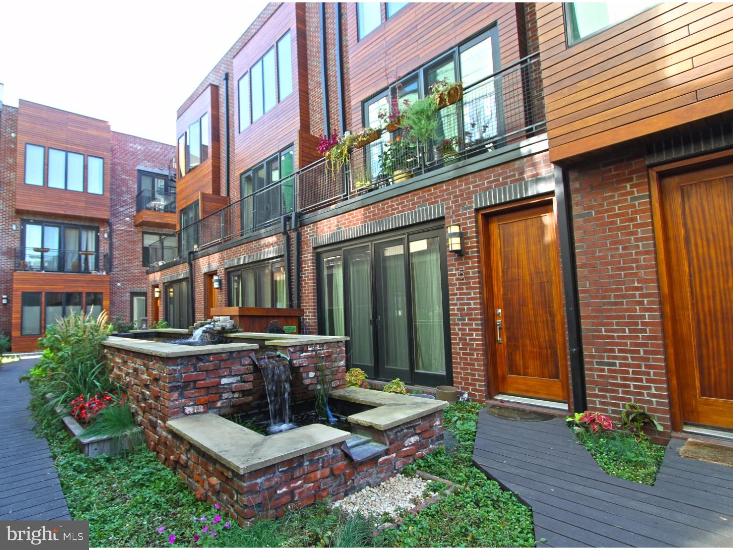 This spectacular LEED certified, Ice House Phase I unit located on the Koi Pond level is a 1 bedroom flat, 1 bath unit, offering 674 sf of living space, and one car garage parking! In addition to a lovely front patio, the interior features include field finished oak hardwood floors throughout, recessed lights, a custom kitchen with Energy Star stainless appliances, Quartz Counter tops and a large island with ample seating, flat panel bamboo cabinetry, stainless under mount sink with goose neck chef's faucet, pendant lighting, and stunning glass back splash. Spacious bathroom with custom tile. Large bedroom with a massive closet. Laundry room with stack front load washer and dryer. Common areas include rain water conservation system, gray water hos bib located in the garage, the Koi Pond, Park over look common deck facing Thompson St., a roof top Dog Park with unmatched Panoramic Views, common deck and green roof with furnishings, a grill, and concierge station. This private community is like none other in Philadelphia. Note: High efficiency utilities, unbelievably low utility bills, bike storage room, private trash removal, low condo fees, 8 yrs remaining on the Builder Warranty and VA friendly.