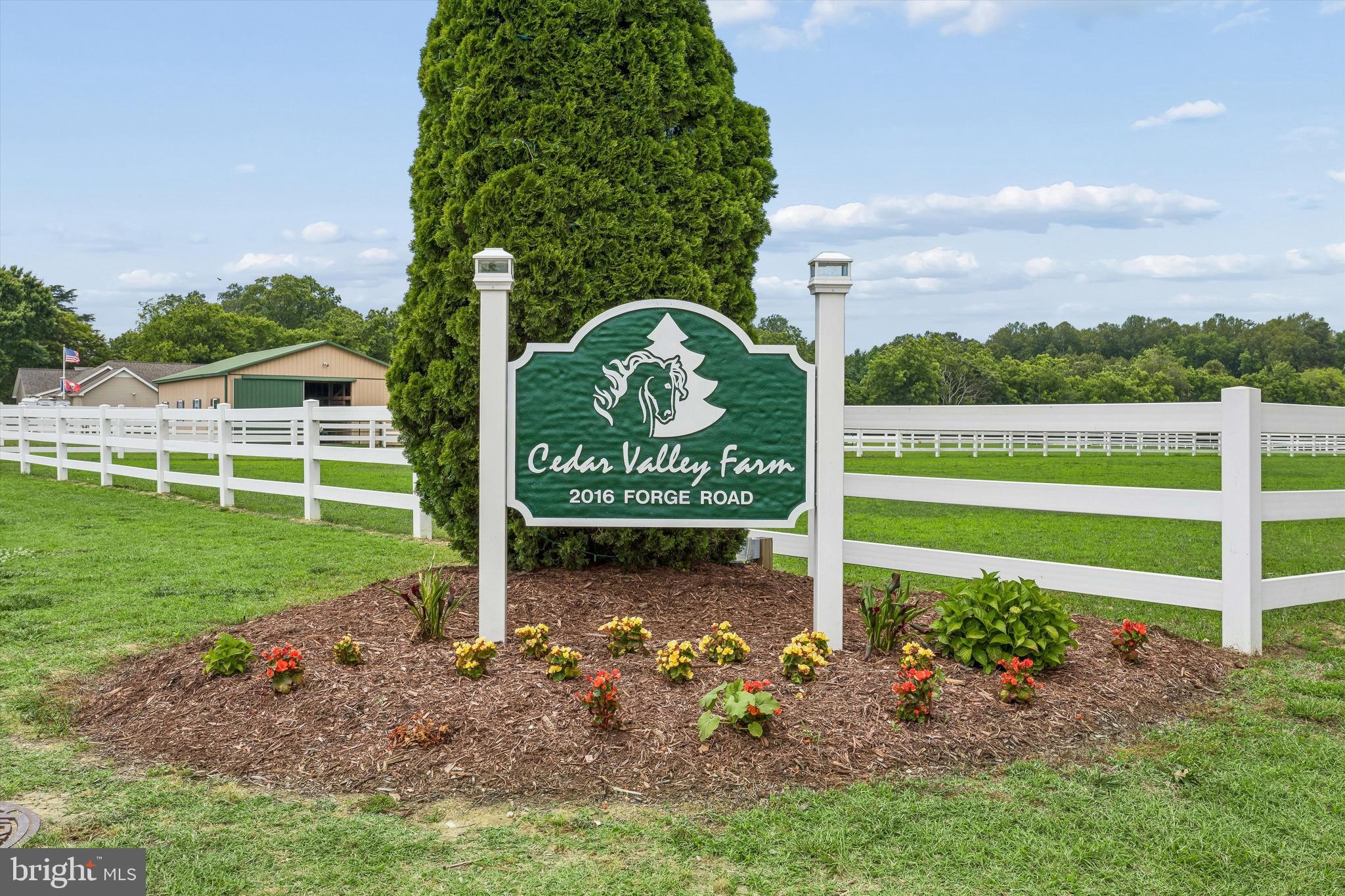 Cedar Valley Farm presents a rare opportunity to acquire an established equestrian facility in the heart of James City County. Situated on approximately 40 acres, this premier horse property is thoughtfully designed for boarding, training, lesson programs, or private use and features extensive equestrian infrastructure rarely found in the region. The facility includes approximately 37 stalls across multiple barns, a large indoor riding arena, outdoor riding arena, multiple tack rooms, wash stalls with hot and cold water, exterior wash rack, hay and shavings storage, automatic watering systems, and a variety of private, semi-private, and group turnout options. Extensive PVC fencing, electric-fenced paddocks, run-in sheds, and well-planned pasture layouts create a highly functional environment for both horses and operators. Complementing the equestrian operation are two residences. The original farmhouse offers over 3,000 square feet of living space, while the newer craftsman-style carriage home provides approximately 2,755 square feet of additional living accommodations ideal for owners, trainers, staff, guests, or rental income. Whether expanding an existing equestrian business, launching a premier training operation, or creating a private horse estate, Cedar Valley Farms offers the infrastructure, acreage, and versatility to support a wide range of equestrian pursuits.
