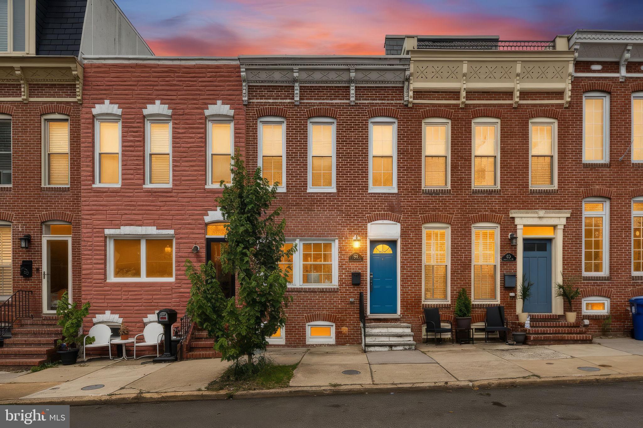 Welcome to 1718 Johnson Street, a beautifully maintained brick-front row home offering 2 bedrooms, 2 full bathrooms, and timeless Baltimore charm in the highly sought-after Federal Hill/Riverside neighborhood, just steps from Riverside Park. Filled with natural light, the main level showcases exposed brick, hardwood floors, a wood-burning fireplace, and a dedicated dining area, creating a warm and inviting atmosphere. The well-appointed kitchen features granite countertops, stainless steel appliances, and ample cabinet and prep space for everyday living and entertaining. Upstairs, the spacious primary bedroom offers wide-plank LVP flooring, neutral finishes, a ceiling fan, and a double-door closet. The renovated hall bathroom features a large vanity with generous storage, classic white subway tile, and a luxurious walk-in shower. The second bedroom is a versatile space ideal for guests or a home office and includes a Murphy bed, en-suite full bathroom with a tub/shower combination, and access to a private rear balcony. Upper-level laundry adds everyday convenience. Step outside to a fully fenced backyard retreat featuring a spacious patio with a blend of sun and shade, perfect for relaxing, entertaining, or enjoying outdoor dining. The unfinished basement provides abundant storage and additional utility space. Situated on a quiet one-way street just steps from Riverside Park with an abundance of angle-in parking spots right outside your front door.  Residents enjoy easy access to scenic walking paths, tennis courts, a community pool, and expansive green space. Conveniently located near Cross Street Market, downtown Baltimore, the University of Maryland Medical Center, Johns Hopkins campuses, and countless neighborhood restaurants, shops, and attractions, this home offers the perfect combination of comfort, character, and city convenience. This one won’t last long, schedule your private showing today! Additional features/updates include: New Roof (2023), New A/C unit installed (2022), Renovated Kitchen and Hall Bath (2022), entire home freshly painted (2021), New Refrigerator/Dishwasher/Microwave (2021).