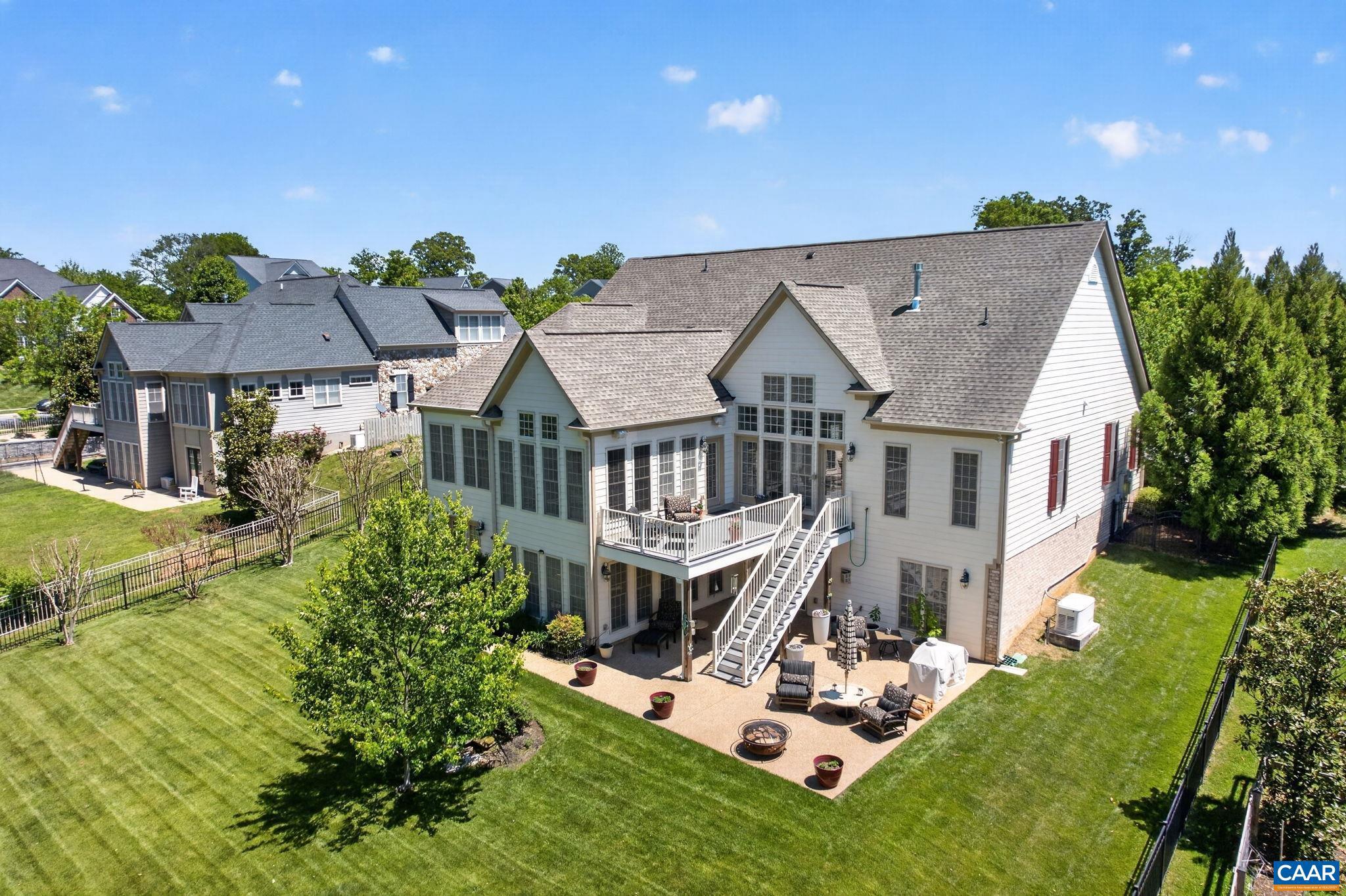 This one-owner, beautifully maintained Craig Builders "Newport" offers the ease of main-level living, a private guest suite with its own kitchen upstairs, and a total of  three finished levels of thoughtfully designed living space on a nearly half-acre homesite. The fully fenced, private backyard, complete with a dedicated garden area and direct access to walking trails, creates an exceptional outdoor lifestyle. Inside, gracious living spaces are designed for both everyday comfort and entertaining. The sunroom just off the gourmet kitchen provides a light-filled retreat, offering winter mountain views. The beautiful primary suite, two additional bedrooms, a full bath, half bath, home office, and laundry, complete this level. The private upper-level suite with a kitchen offers outstanding flexibility for extended family, guests, an au pair, a caregiver, or multigenerational living. The finished terrace level expands the possibilities even further, featuring abundant space for recreation, fitness, hobbies, a future wine cellar, media room, or home theater.  One of Old Trail's most desirable settings, this special property presents a rare opportunity to enjoy the best of Crozet. Just 20 minutes to downtown Charlottesville, and UVA!,Glass Front Cabinets,Granite Counter,Maple Cabinets,Fireplace in Basement,Fireplace in Great Room