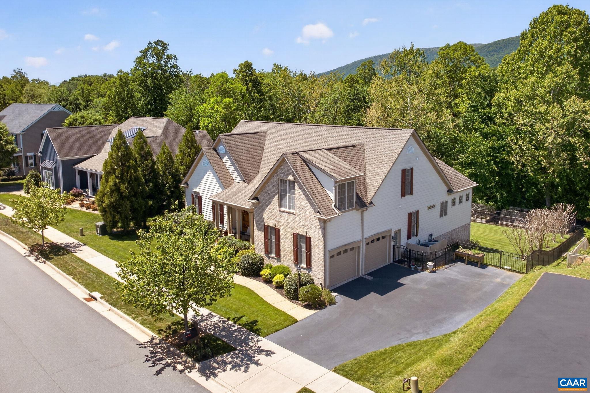 First time offered in sought-after Old Trail! This beautifully maintained Craig Builders "Newport" offers the ease of main-level living, a private guest suite with its own kitchen, and three finished levels of thoughtfully designed living space on a nearly half-acre homesite. The fully fenced, private backyard, complete with a dedicated garden area and direct access to walking trails, creates an exceptional outdoor lifestyle. Inside, gracious living spaces are designed for both everyday comfort and entertaining. The sunroom just off the gourmet kitchen provides a light-filled retreat, offering winter mountain views. The beautiful primary suite, two additional bedrooms, a full bath, half bath, and home office, and laundry, complete this level. The private upper-level suite with a kitchen offers outstanding flexibility for extended family, guests, an au pair, a caregiver, or multigenerational living. The finished terrace level expands the possibilities even further, featuring abundant space for recreation, fitness, hobbies, a future wine cellar, media room, or home theater.  One of Old Trail's most desirable settings, this special property presents a rare opportunity to enjoy the best of Crozet.,Glass Front Cabinets,Granite Counter,Maple Cabinets,Fireplace in Basement,Fireplace in Great Room