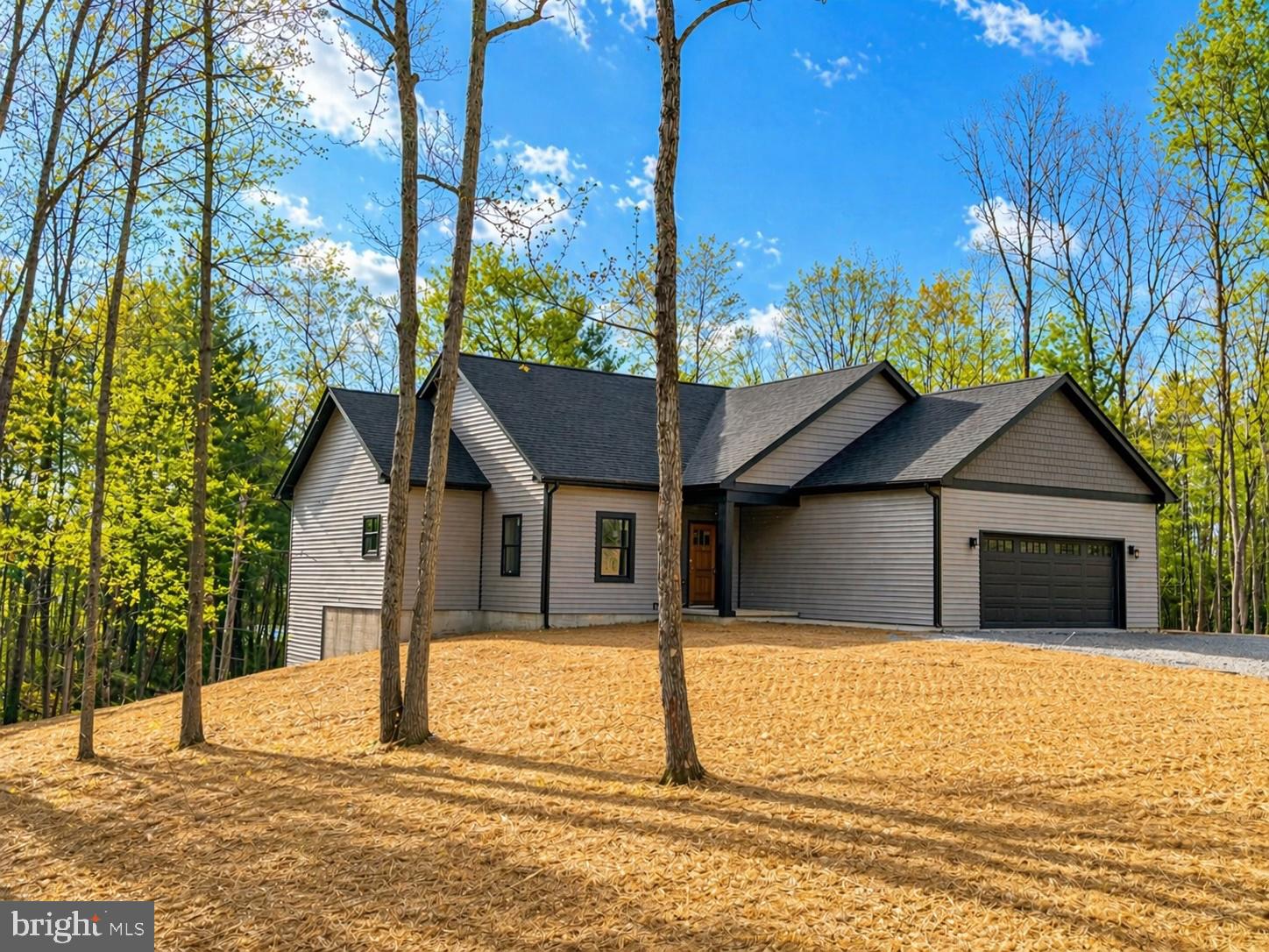House is complete and ready to close.  Photos as of April 23. .    Welcome to this beautifully designed home on a wooded 2+ acre lot in Hedgesville!!   The main level offers 3 spacious bedrooms,  2.5  bathrooms.   The kitchen features stainless steel appliances and granite countertops, opening to a bright living area ideal for entertaining. The fully finished basement provides additional living space and includes a full bathroom and huge rec room.  . Enjoy privacy, comfort, and modern finishes surrounded by nature — your peaceful retreat awaits!