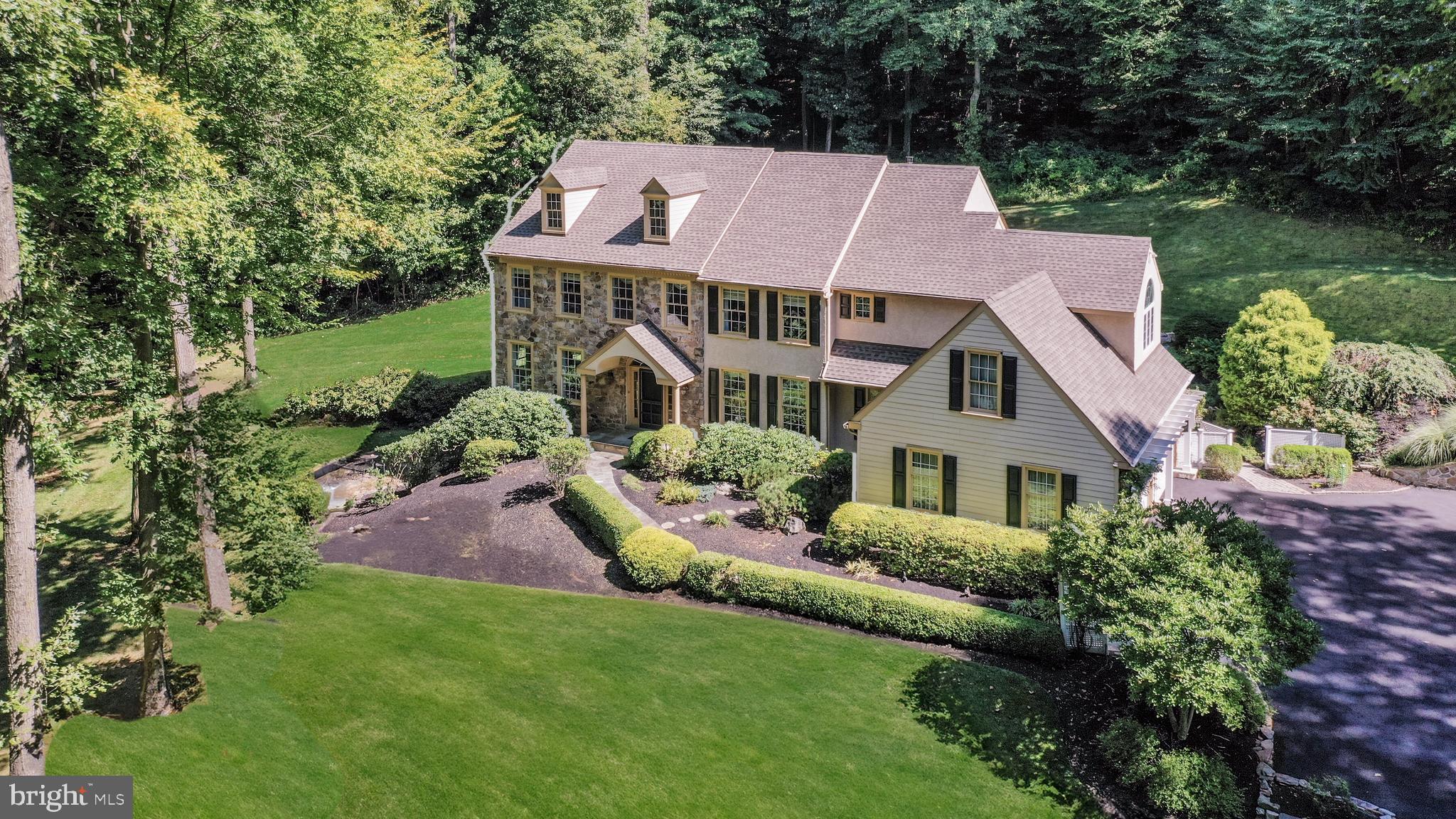 Breathtaking EAGLES-EYE  Views of Chester County Natural Beauty
Located in historic Birchrunville the "little Switzerland of Chester County”, sitting majestically in sublime seclusion, one of the finest homes designed by Ann Capron, meticulously built by Manchester Hall is the home of the late Eagles Super bowl player, Frank LeMaster.

Graced by tall trees surrounding the glorious grounds, a bounty of windows capture panoramic views of gardens, lush greenery, and faraway mountain peaks enriching the landscape. From twin eagle pillars adorning the 8-acre property entrance to a newly paved winding driveway, complete with underground lighting, an alarm system, and automatic illumination as you approach the garage to the first glimpse of the unmatched estate home each delightful discovery will take your breath away.
    
The custom home exhibits exceptional craftsmanship, superb quality features, and extraordinary attention to detail. The welcoming reception room, impressive winding staircase, custom moldings, site finished hardwood floors, built-in speakers, formal dining room, grand in entertaining space, features custom chair rails, a second stairway is conveniently positioned between the kitchen and dining room. Additional living area adjoins a private study.

The vaulted ceiling Great Room is a concert of construction compatibility. The stunning arch-capped floor-to-ceiling window view expands all the way from a brick patio with pergola to a high hillside. Composed of coveted Chester County stone, the FP is a focal point of this gathering spot which includes an informal dining/entertaining area. And – it seamlessly leads to the kitchen.

 A true gourmet kitchen, it includes everything a homeowner who loves to cook and entertain could wish for. The large double-door pantry, which provides abundant storage space, matches creamy custom cabinetry with built-in drawers. A huge Palladium window bathes the room in natural light, while new sliding glass doors to the custom patio easily enable the chef to serve outdoor guests. Top-of-the-line appliances include upper and lower ovens, an island-centered six-burner gas cook top with a mechanical vent, a Bosch side-by-side refrigerator, and two Bosch dishwashers.

 Laundry is a pleasant pastime when the sun shines in to warm the task. Additionally, there is a custom-built ironing board that remains hidden until needed. A central vacuum system is also a household chore convenience.

The fabulous oversized Primary Suite invites vacations every day!  Luxuriate in the Sitting Room by a warm fire. Pamper yourself in the spacious spa-like Primary Bath with SAUNA attached to a walk-in shower or bask in a JACUZZI tub while enjoying hillside views from the two-story Palladium window.  Two walk-in California closets are equipped for any size wardrobe. Three additional bedrooms provide generous storage quarters, as well. And – view after view!

Just when one thought there could be no more wonderment, a French door opens to the lower level. Versatility is the keyword for this 1,200 square-foot recreational haven including door to a lower level patio, there is a home office, media viewing area, bar, game room, exercise room, and full bath with shower. 

This remarkable home is a lifestyle waiting to happen. Secluded and serene, the property requires little maintenance and provides limitless beauty. Beauty that is blessed by views from every window from the bottom to the top of the house.  It’s a short walk to the 5-star Birchrunville Café and the Butterscotch Café for casual breakfast and mouthwatering pastries.
 
Although you may never want to leave 1246 Hollow Road or the Chester Springs vicinity, this spectacular home is just 10 minutes from Route 202 North, which takes you to King of Prussia and the Pennsylvania Turnpike. Nearby, too, are Routes 422 and 76 leading to Center City Philadelphia and the bypass to the airport or 202 South to Delaware and Baltimore.